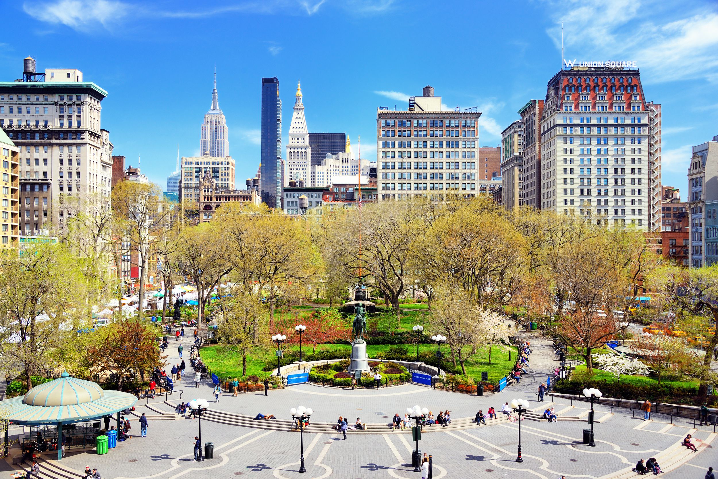 Expansive view of Union Square, Manhattan, south center section surrounded by buildings, on a sunny day during early spring