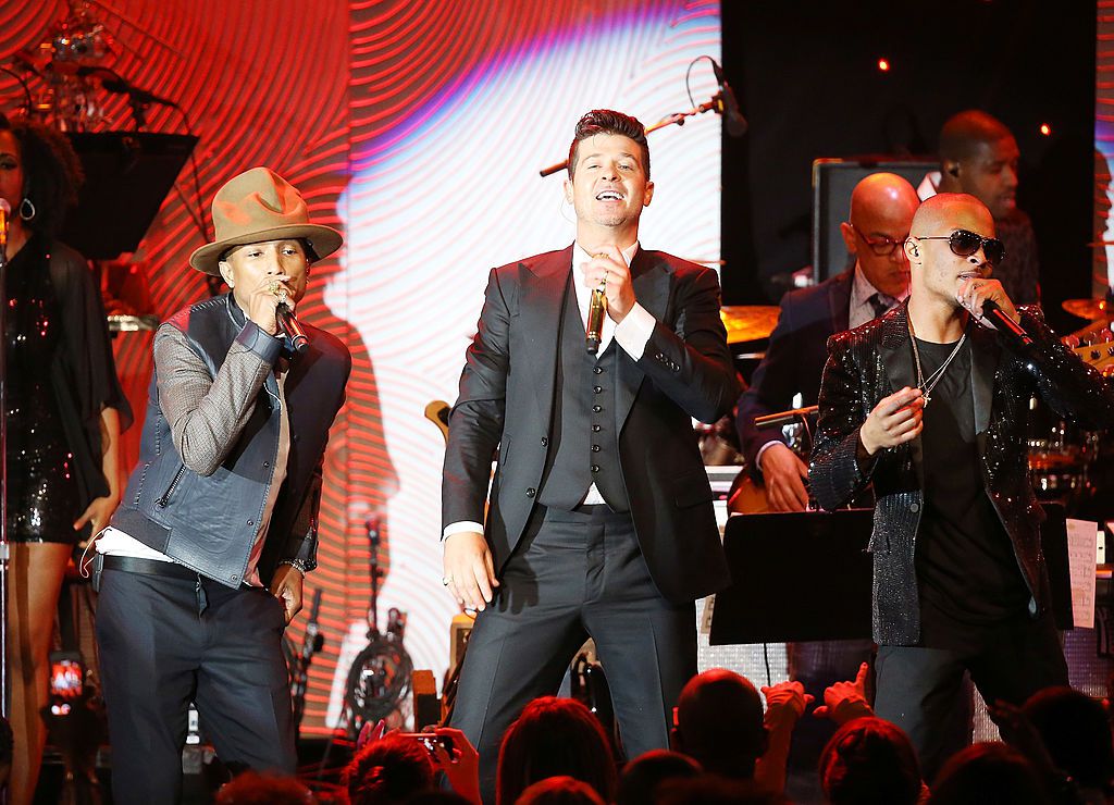 Pharrell Williams, Robin Thicke and T.I. perform onstage during the Clive Davis and The Recording Academy present The Annual Pre-GRAMMY Gala held at The Beverly Hilton Hotel on January 25, 2014 in Beverly Hills, California.