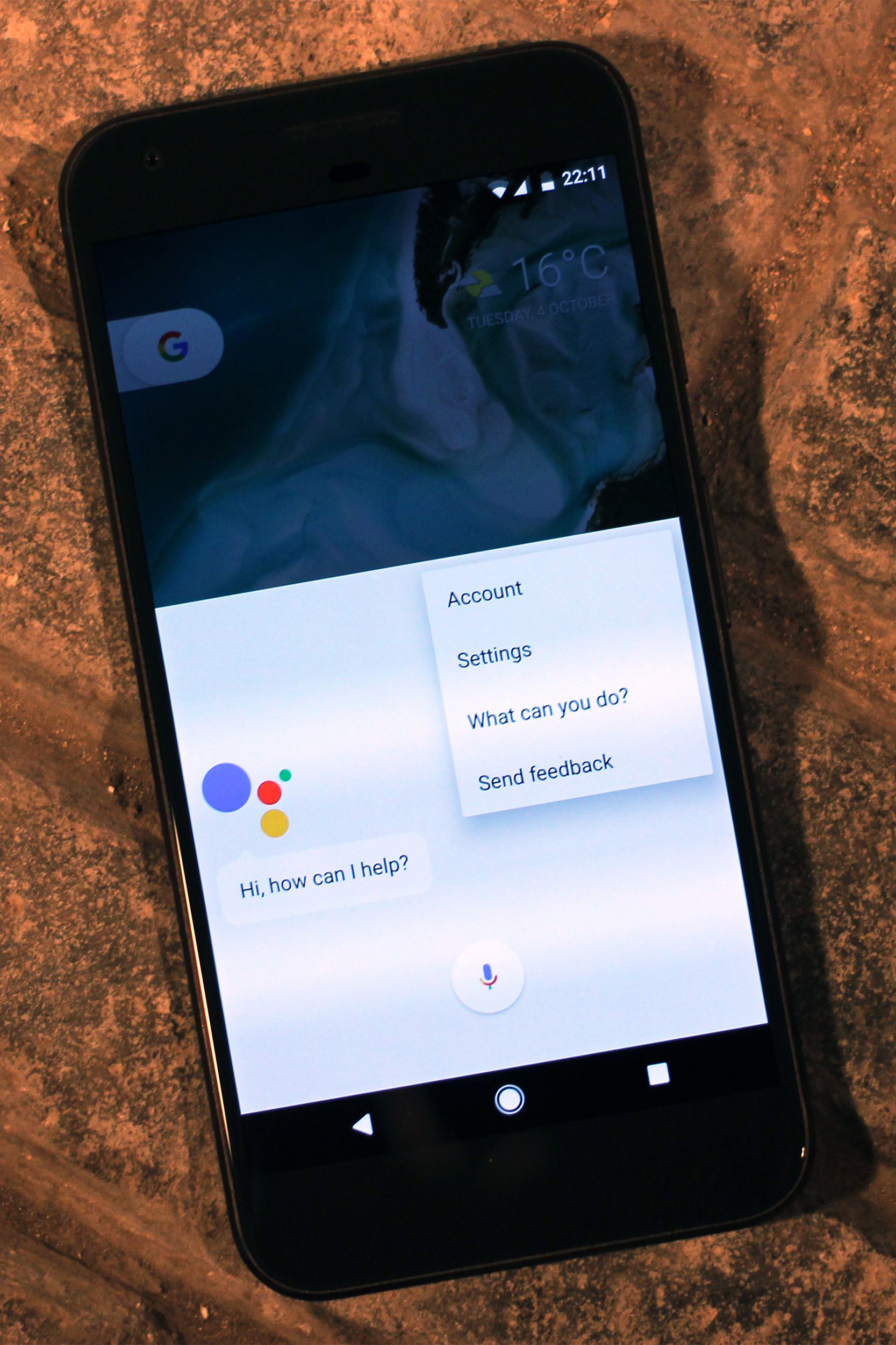 Google Assistant on a Google Pixel XL Smartphone, diagonal towards the left, on a brown veneer table