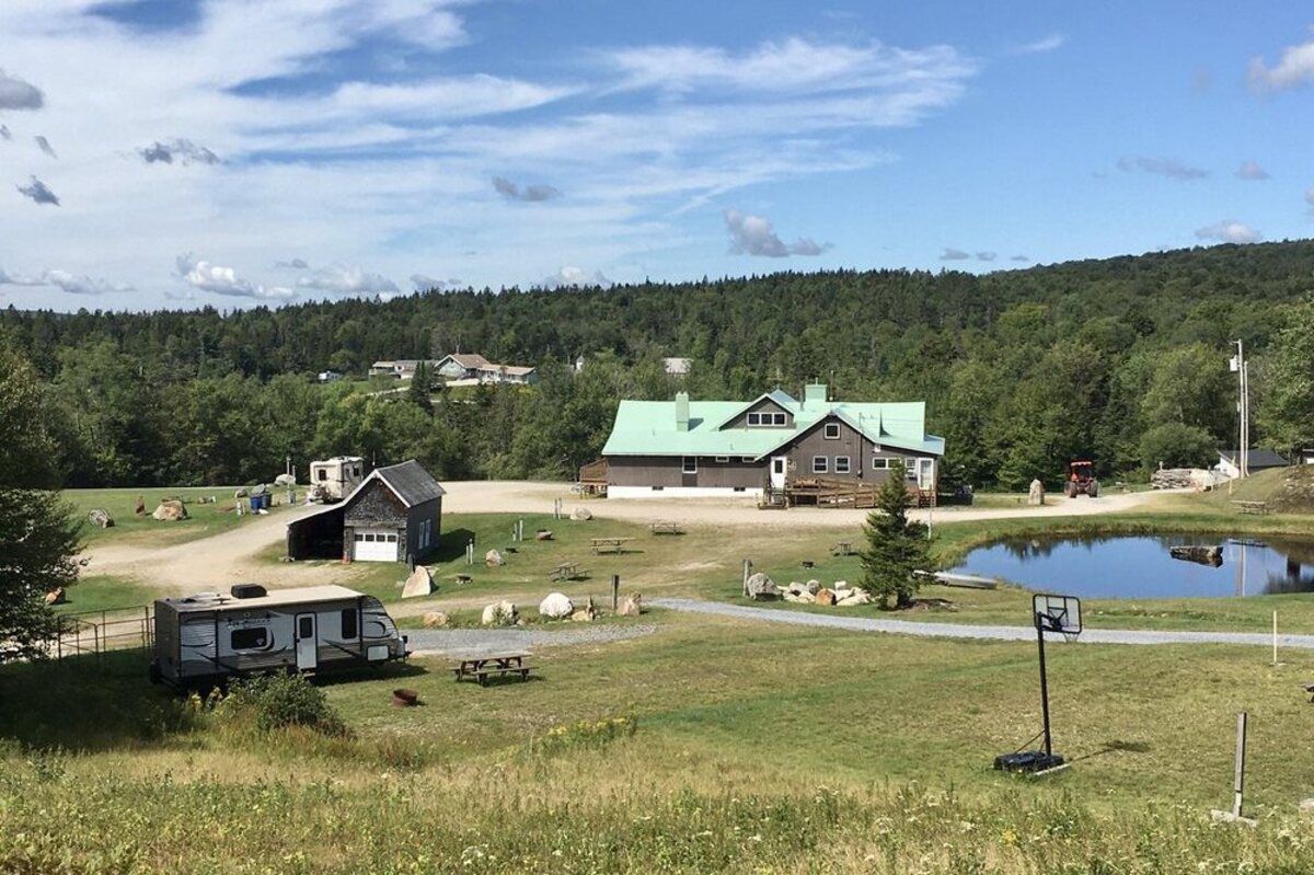 Greenwood Lodge & Campsites, Bennington, Vermont, an RV lot with lodge, office, and a pond