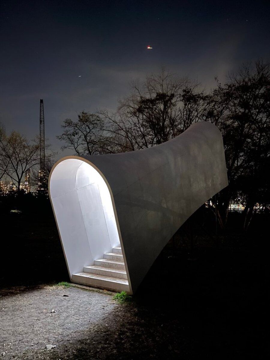 Light tunnel sculpture, Socrates Sculpture Park, Long Island City, during late evening, Manhattan lit in the distance