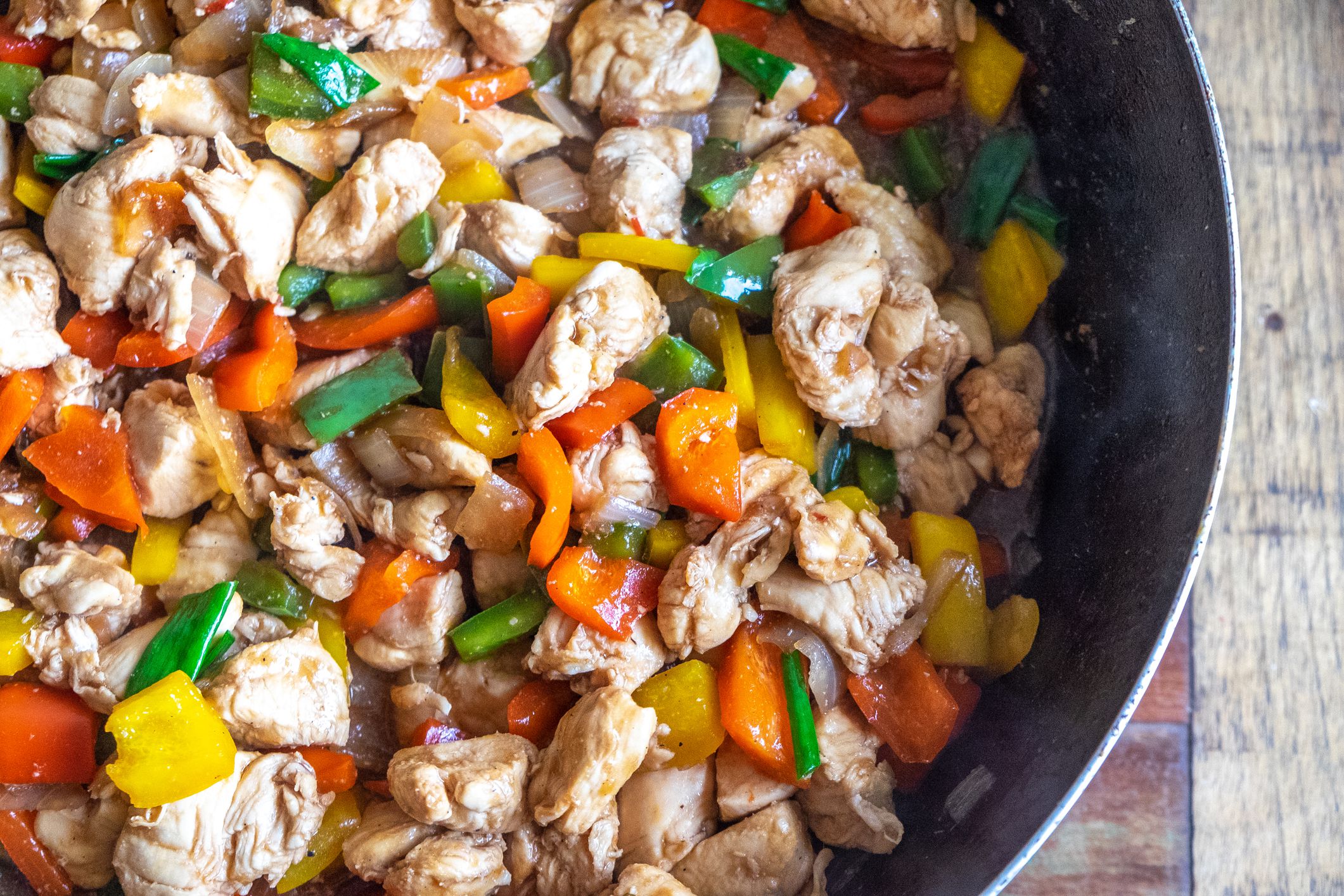 Closeup of one pan 5-ingredient chicken skillet in a skillet on a rustic wooden table