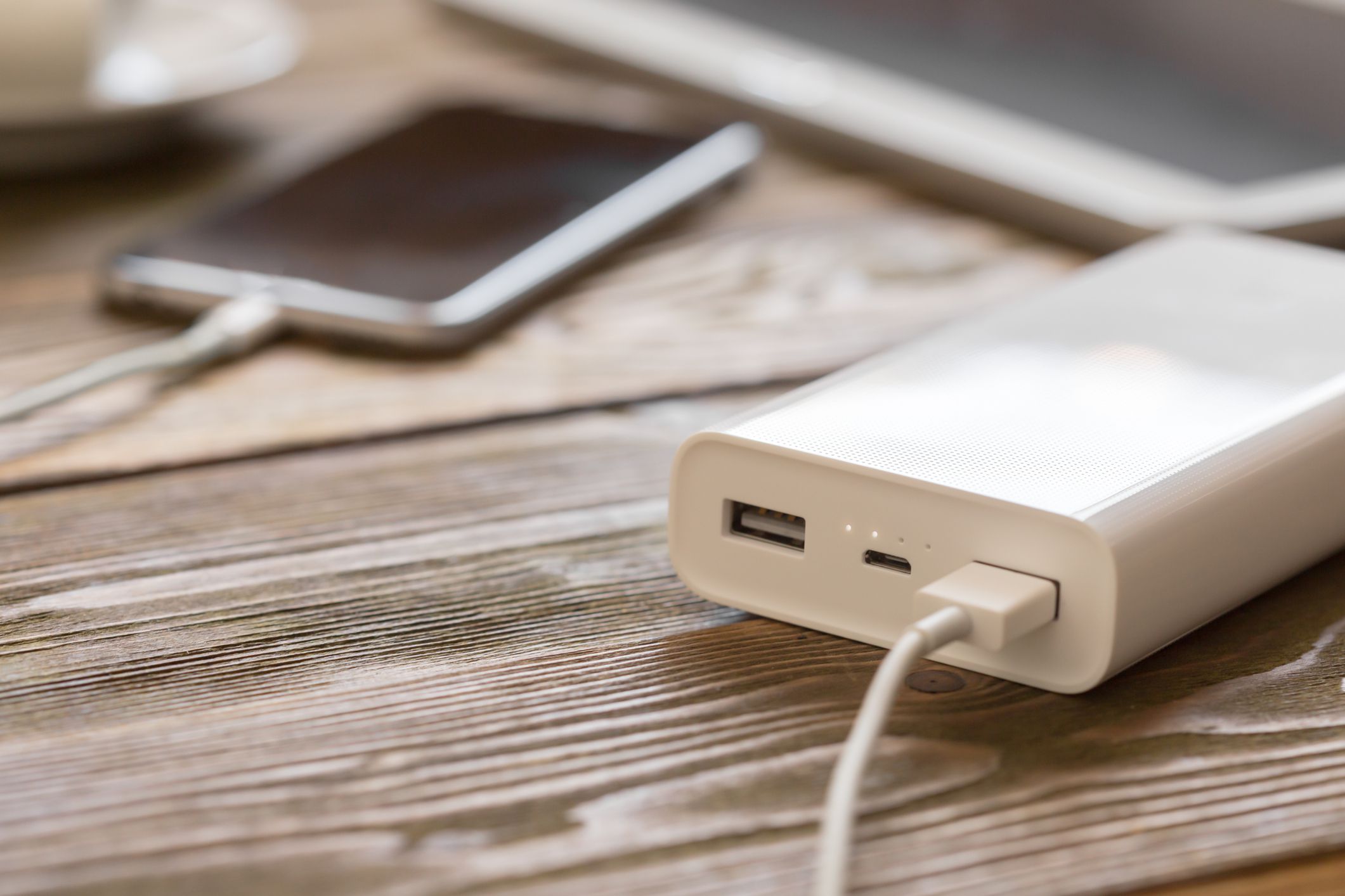 powerbank and cellphone on wooden table