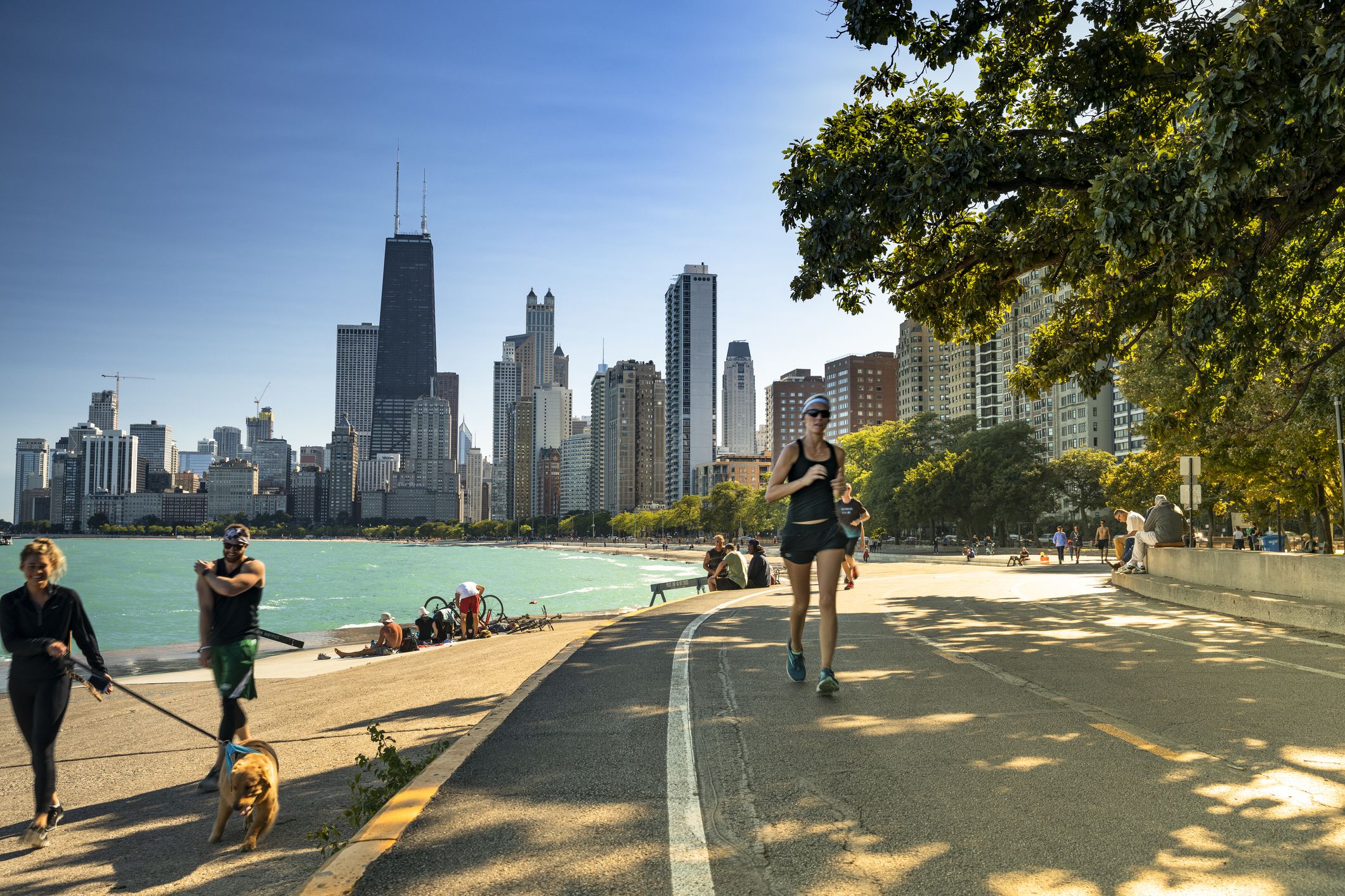 Chicago, Illinois, USA - September 25, 2018: People walk and exercise along the Lakefront Trail on Lake Michigan and Lake Shore Drive in Chicago, Illinois USA.
