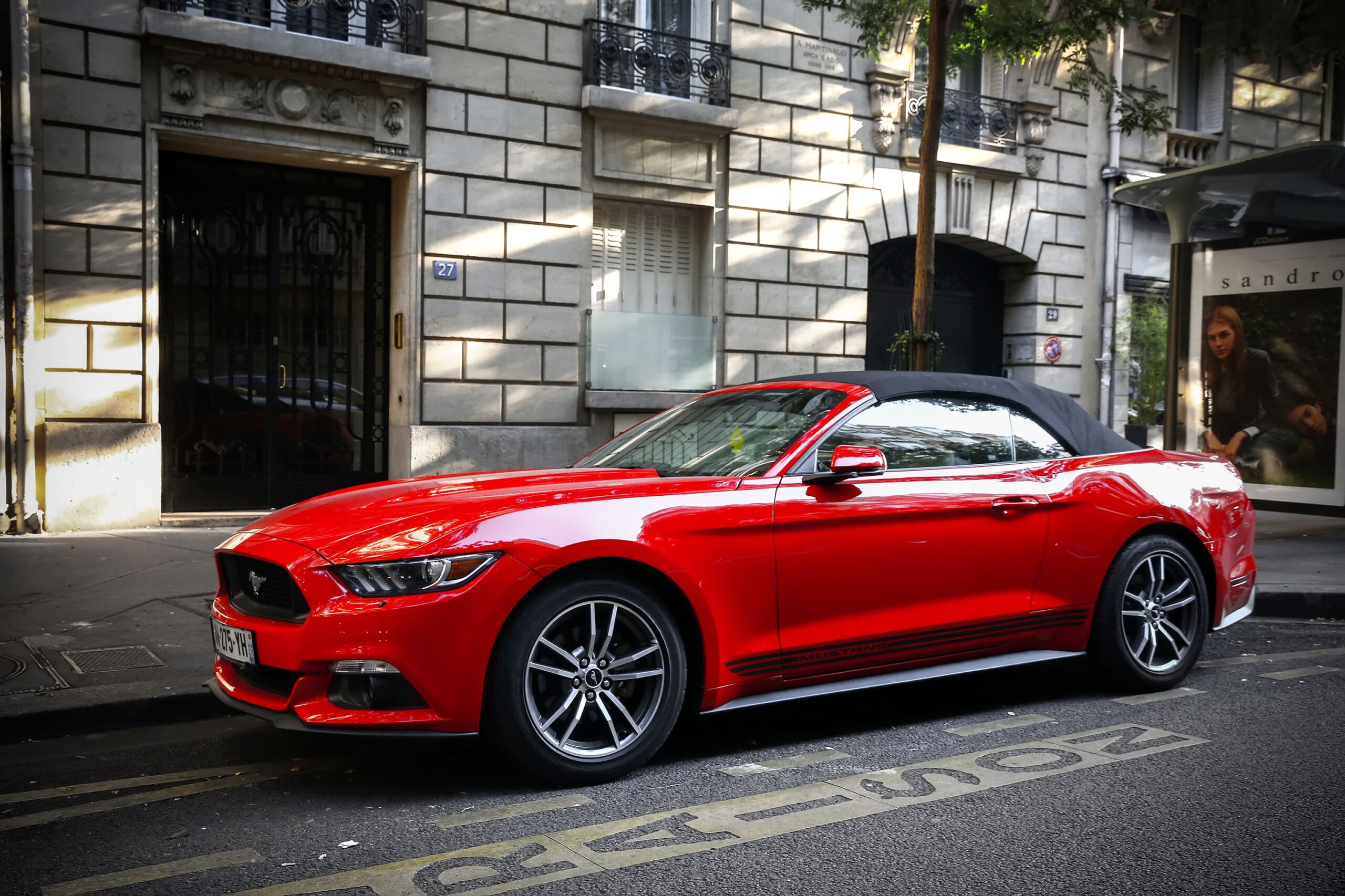 Paris, France - September 15, 2019: Red luxury convertible car Ford Mustang in the city street.
