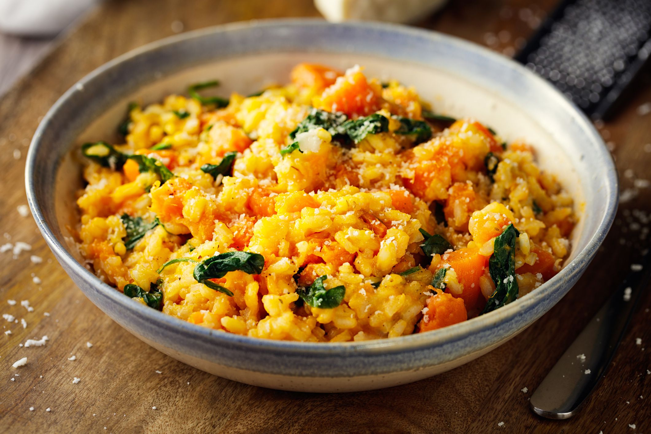 Homemade freshness vegan sweet potato spinach risotto with coconut cream in a bowl