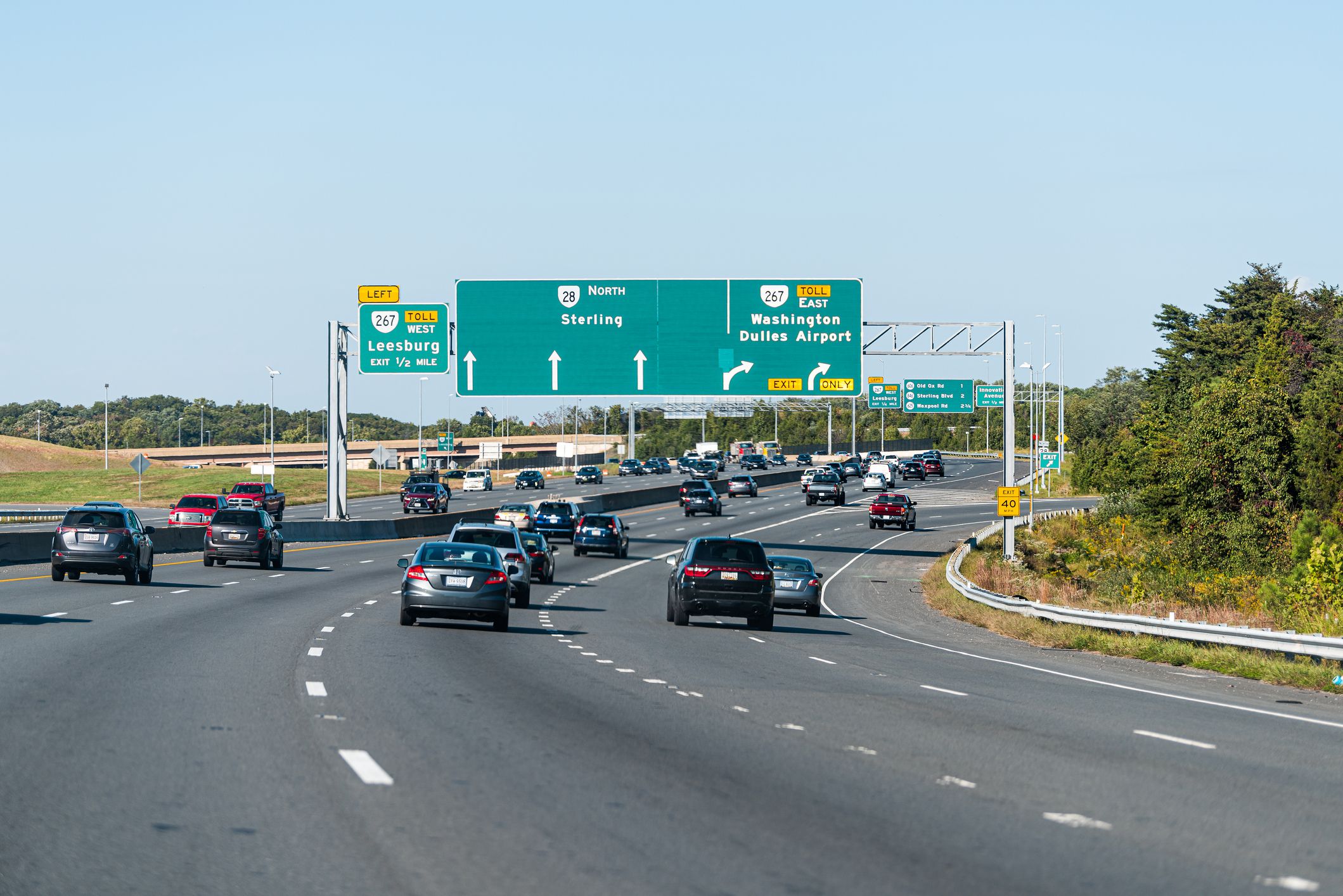 Herndon, USA - October 7, 2020: Sully road 28 multiple lane highway in Northern Virginia with traffic cars and exit sign for Washington Dulles airport, Sterling and Leesburg