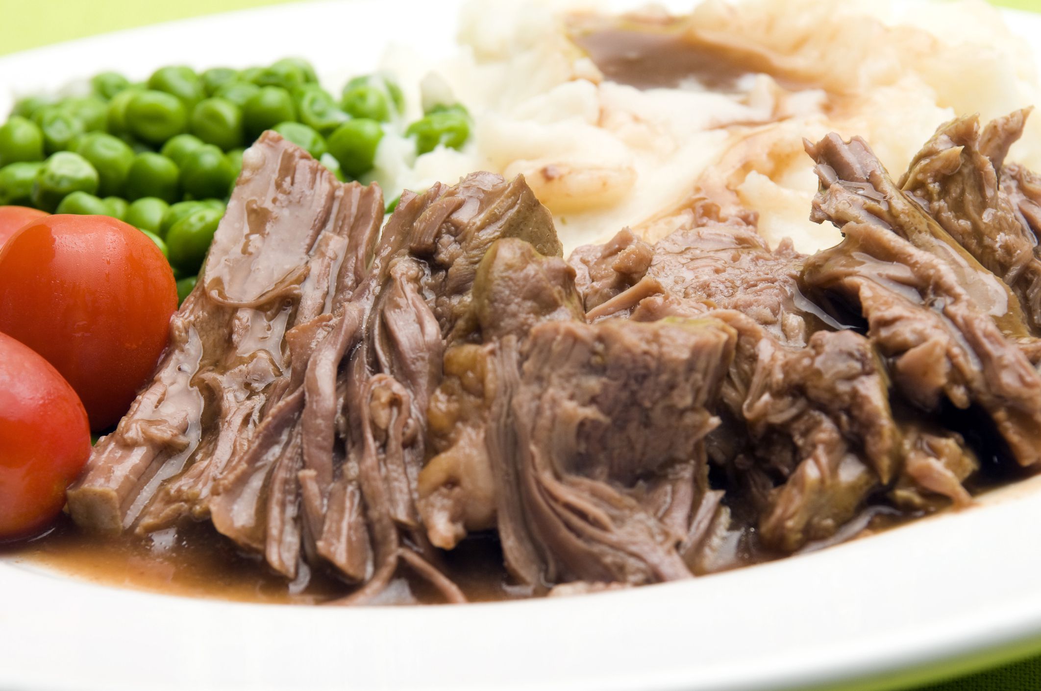pot roast dinner with peas mashed potatoes and gravy