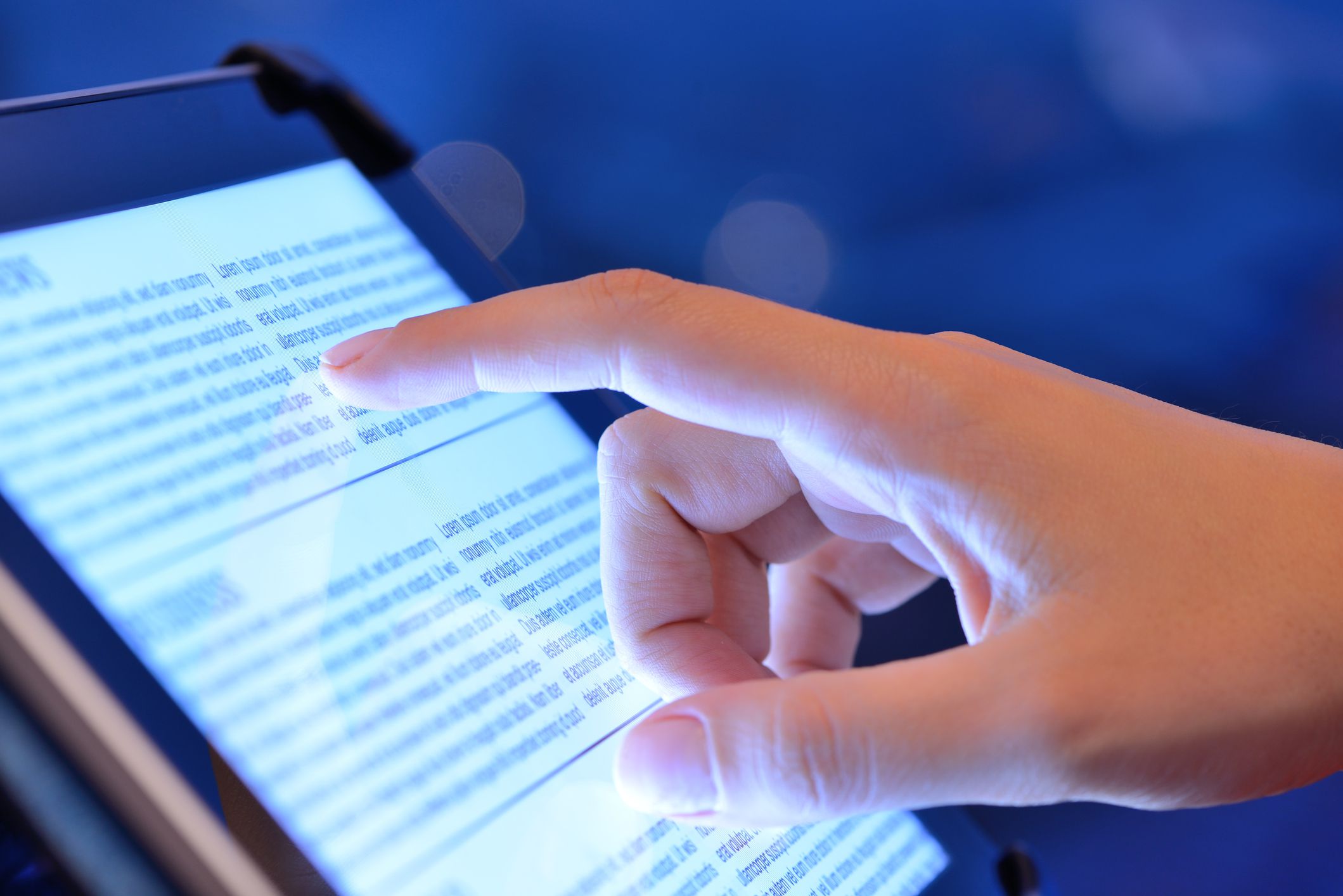 Reading news on tablet computer. Hand touching and using tablet pc.Please see some similar pictures from my portfolio:
