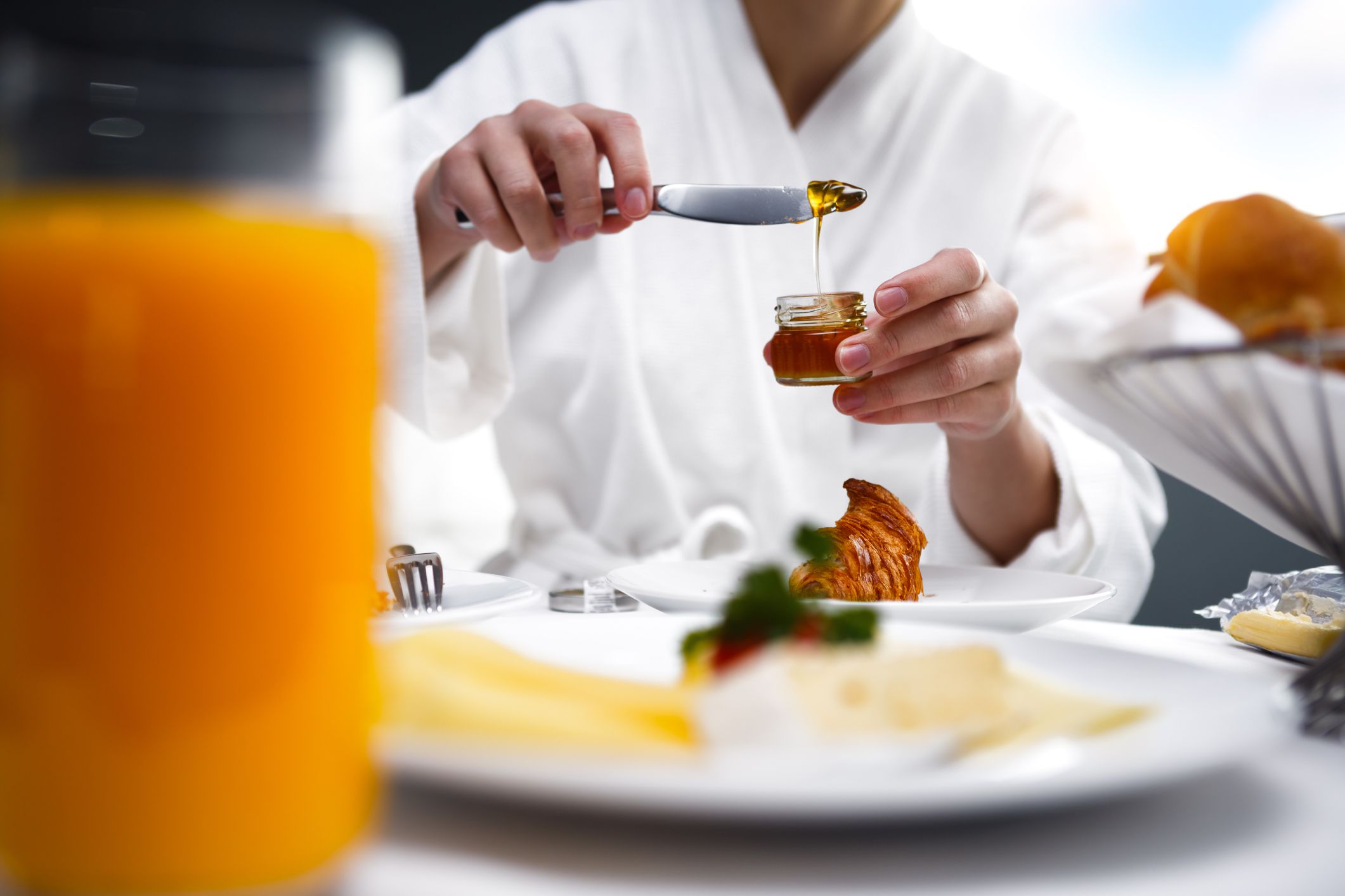 Woman eating breakfast in a hotel room.