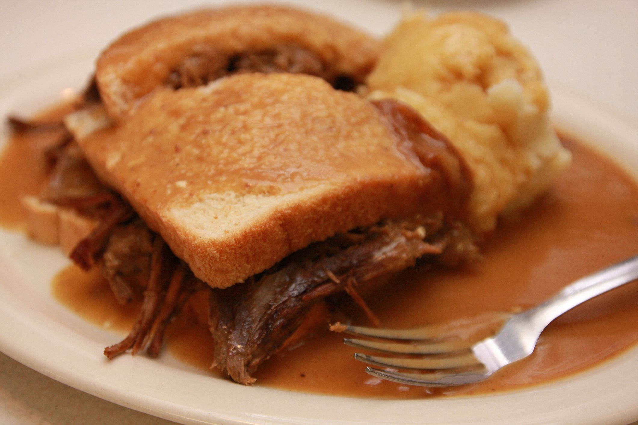 This classic hot beef sandwich, served with slices of white bread and homemade mashed potatoes smothered in gravy, is a favorite at cafes across Iowa.