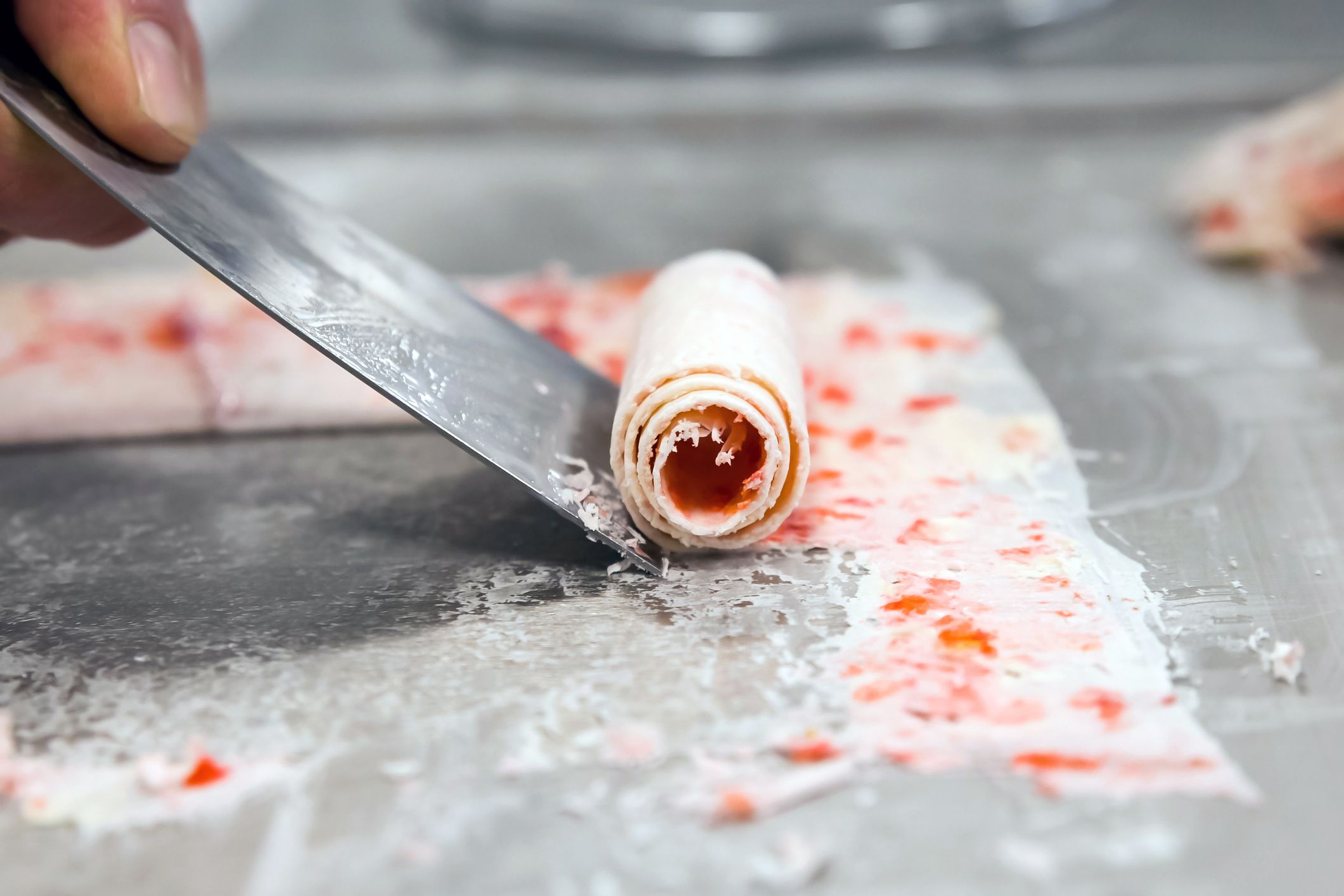 detail of strawberry rolled ice cream on cold plate