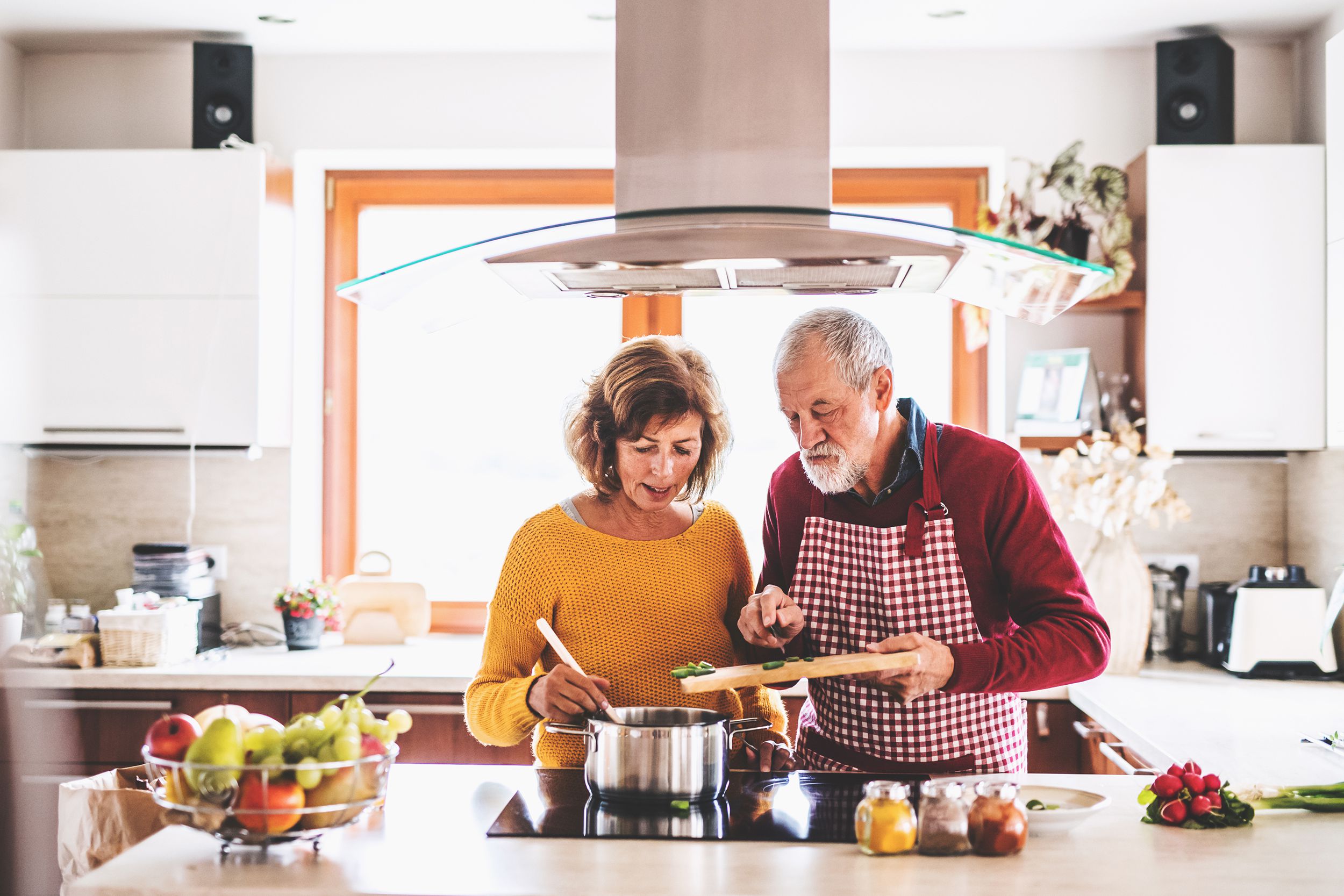 senior couple preparing food in the kitchen