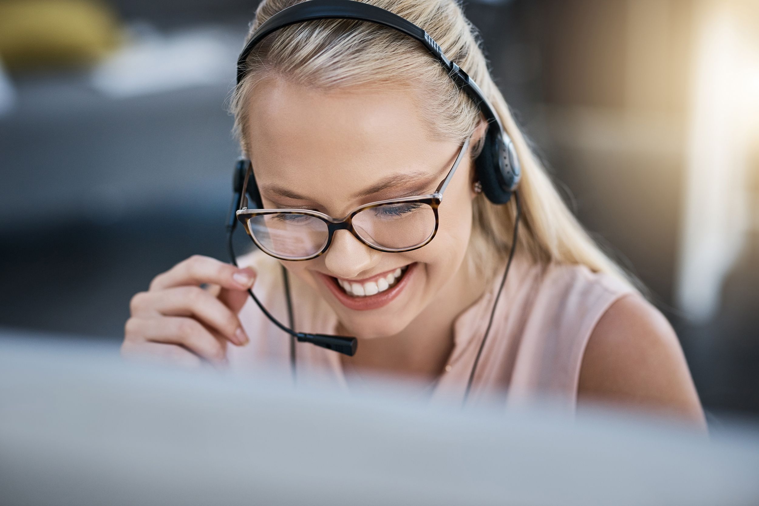 happy telemarketer on computer at work
