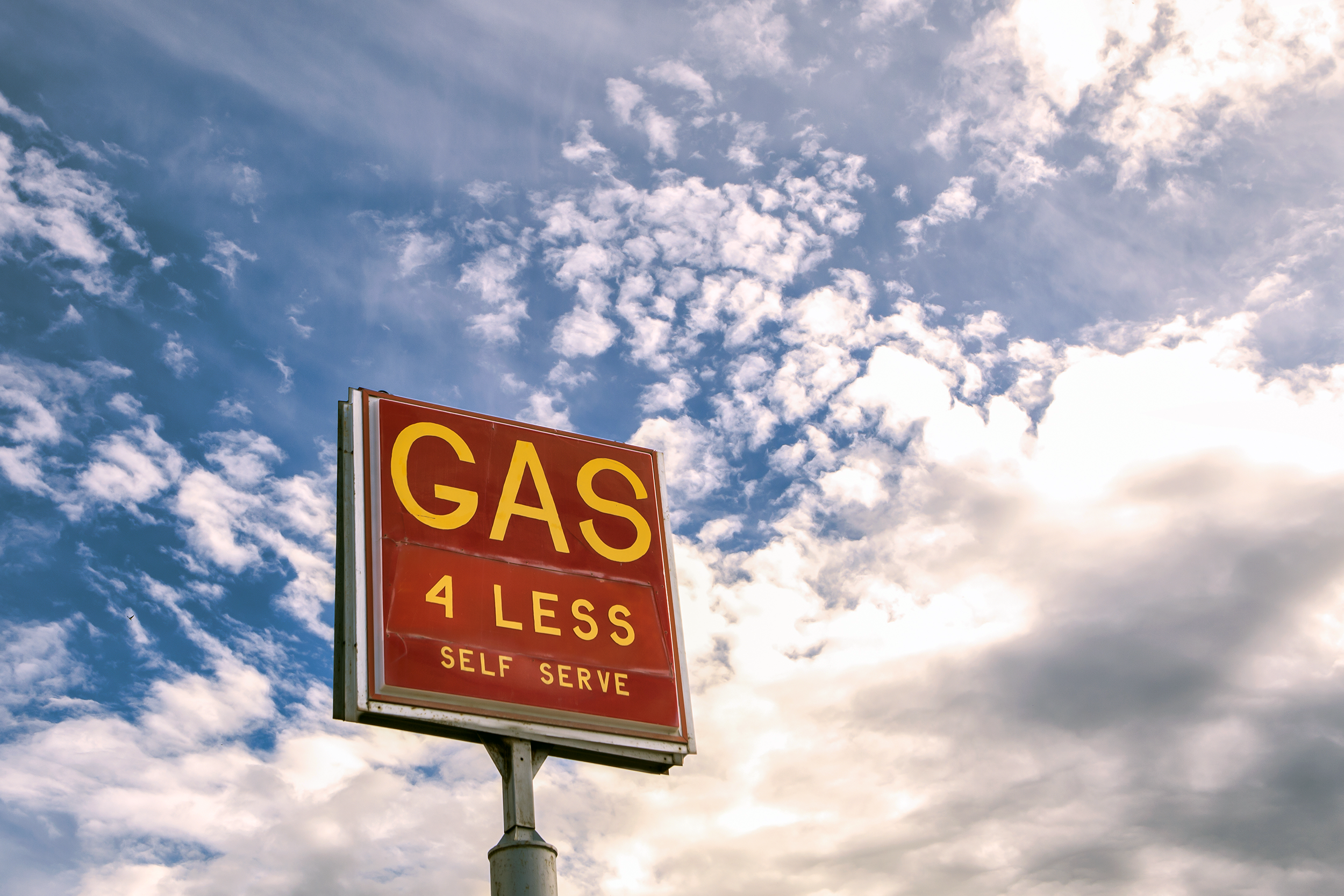 sign for cheap gas in a deserted setting