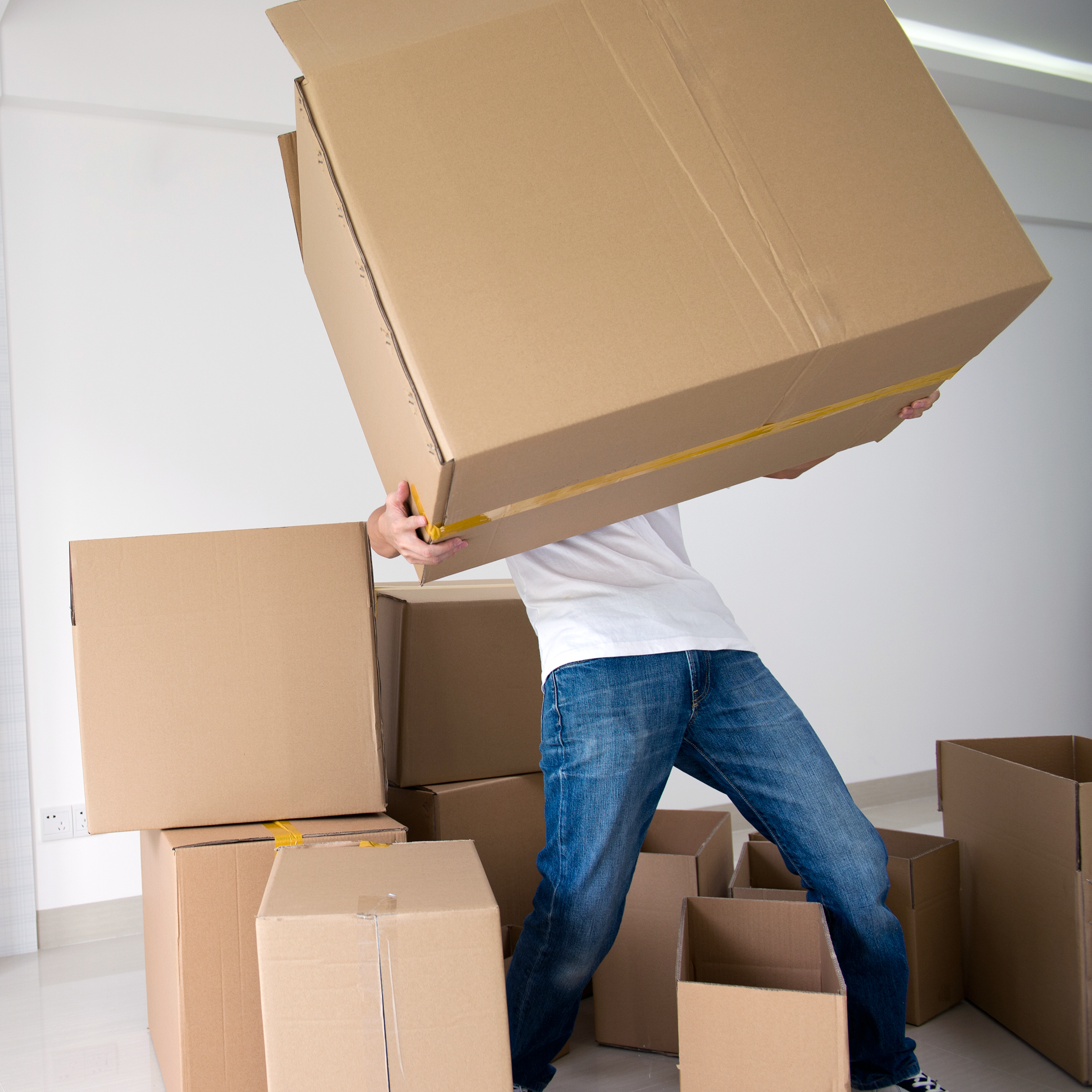 man carrying a really heaving moving box
