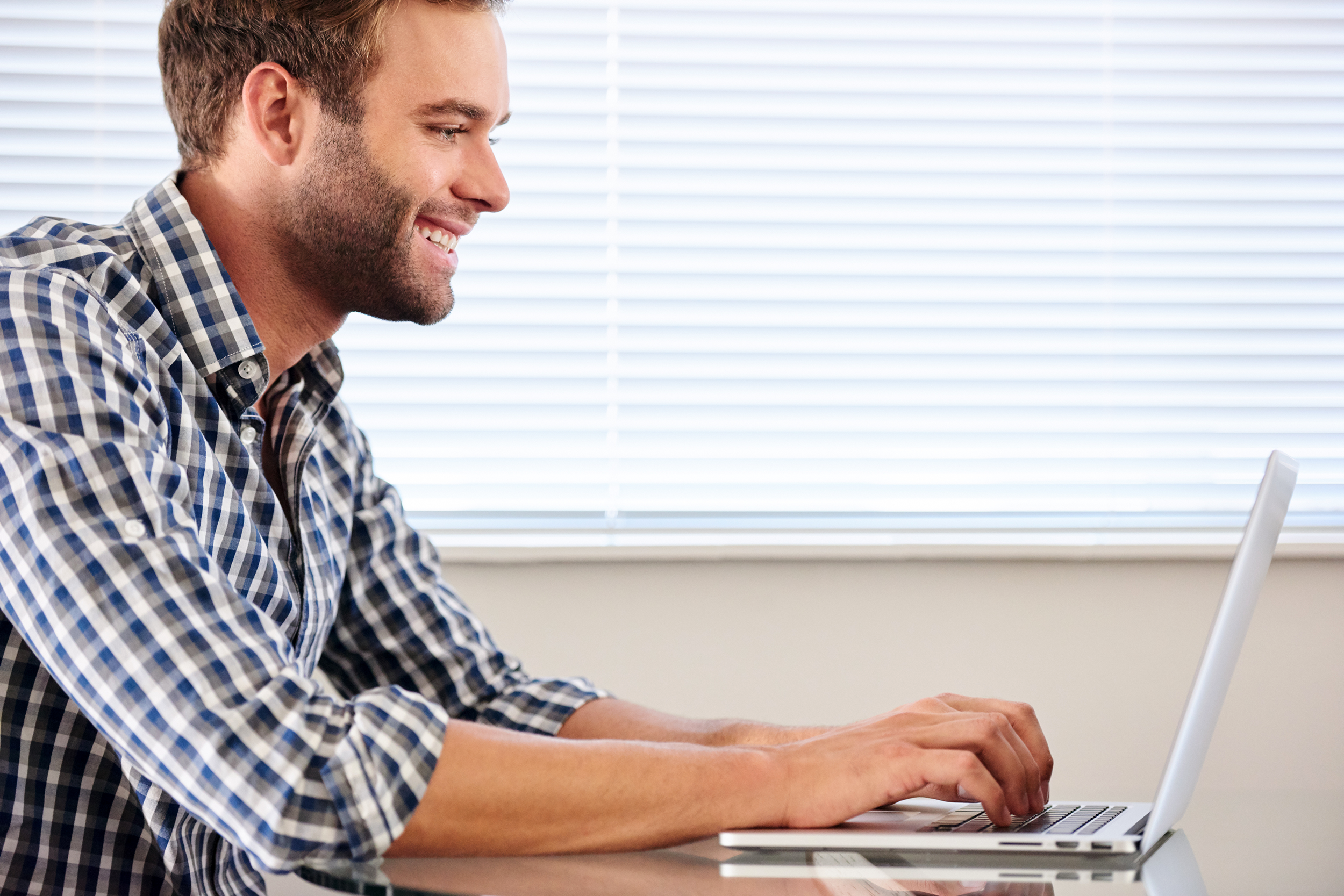 Man surfing the Internet at home on his laptop