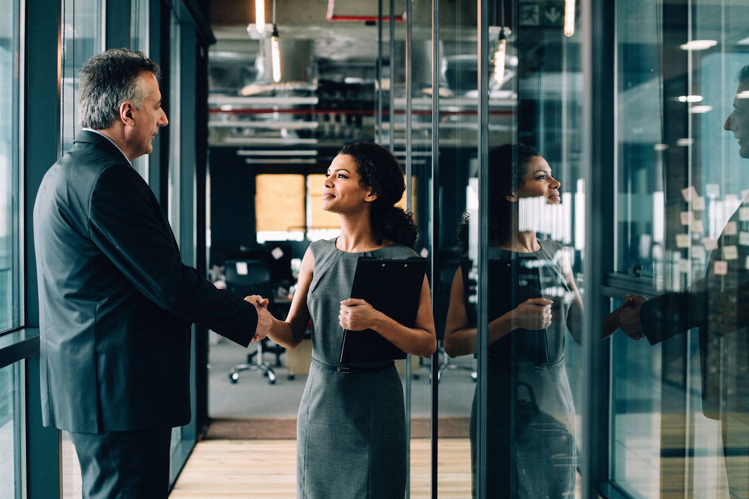 businesswoman and businessman shaking hands