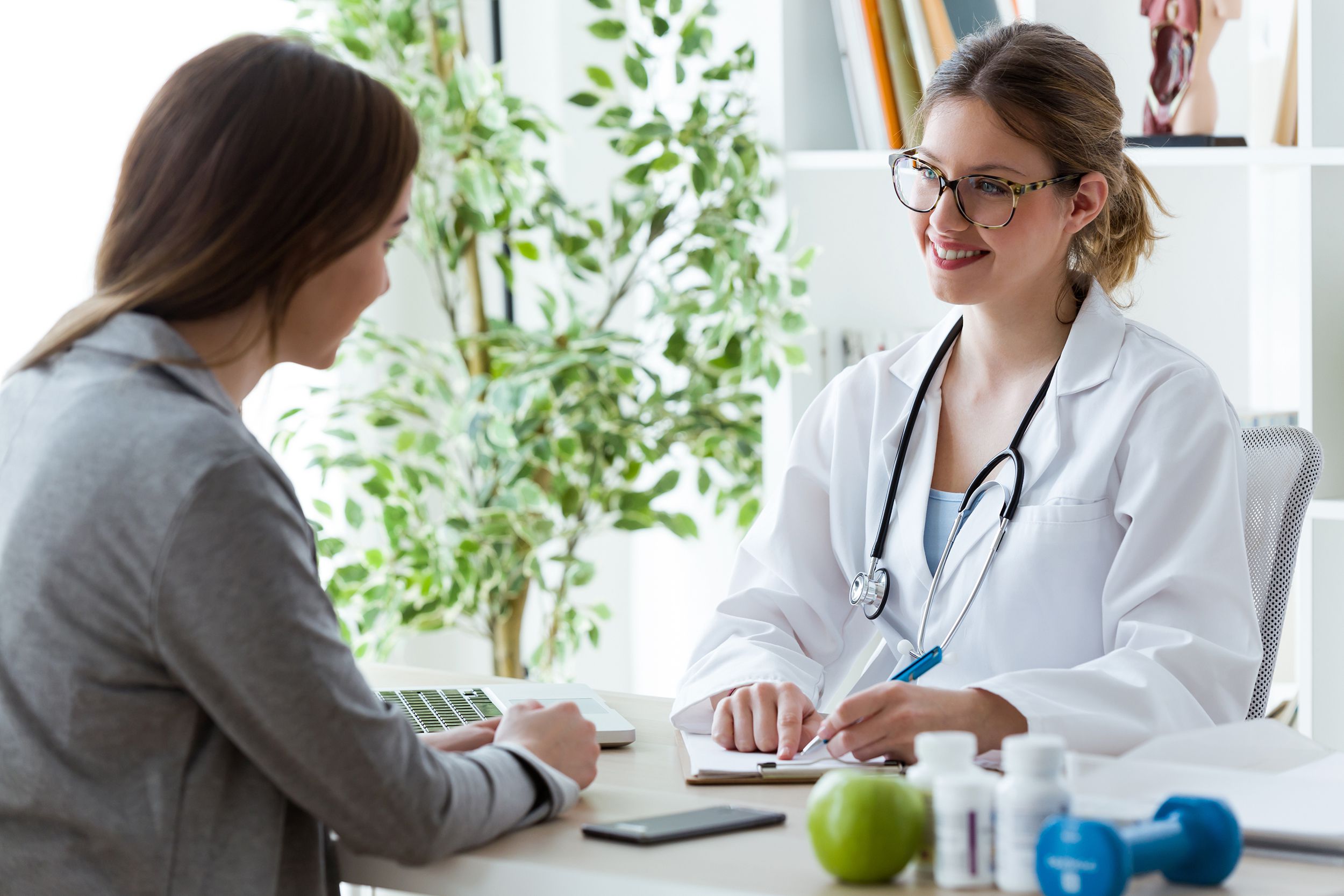 young woman talking with dietician about her health in the consultation