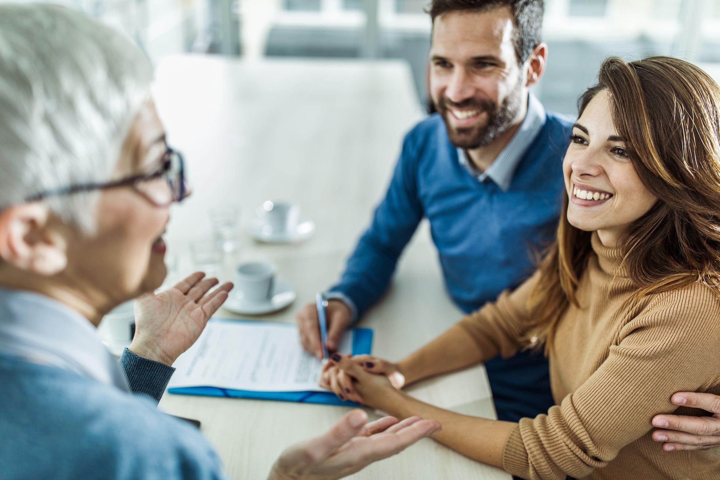 happy couple communicating with their financial advisor on a meeting in the office
