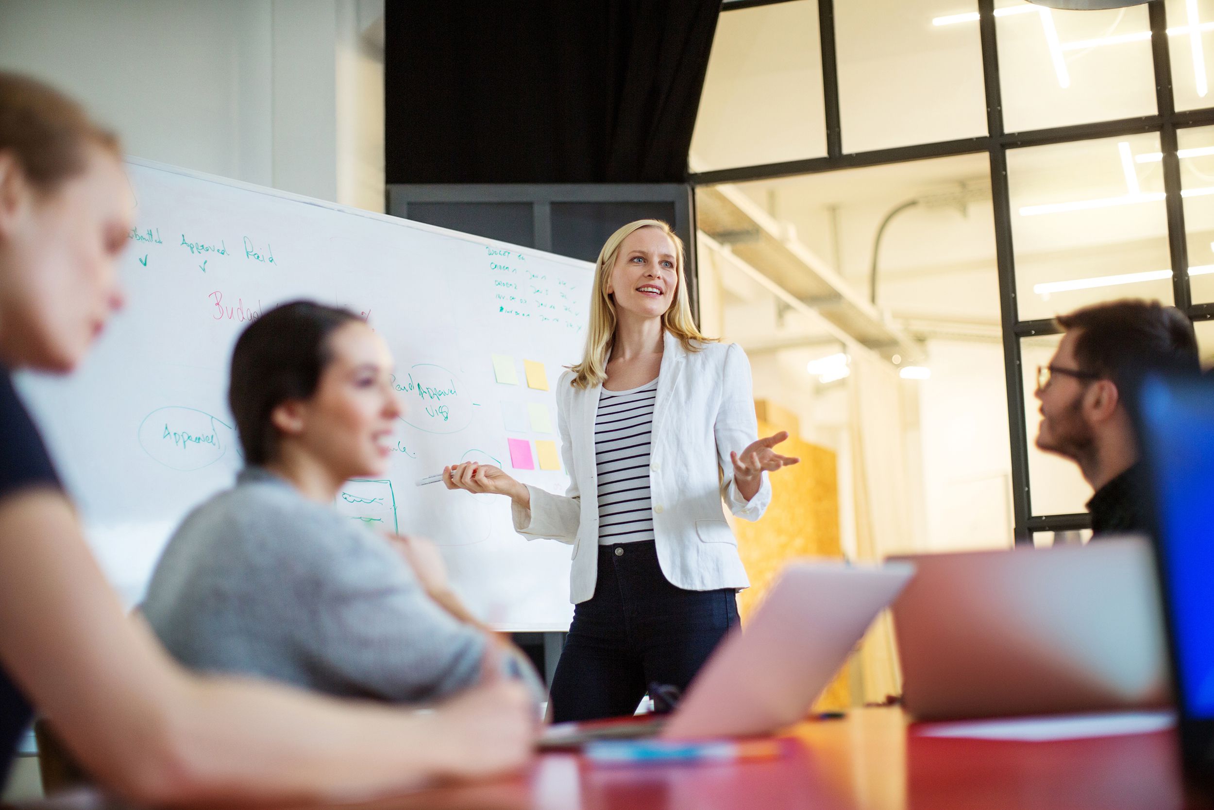 businesswoman giving presentation on future plans to colleagues