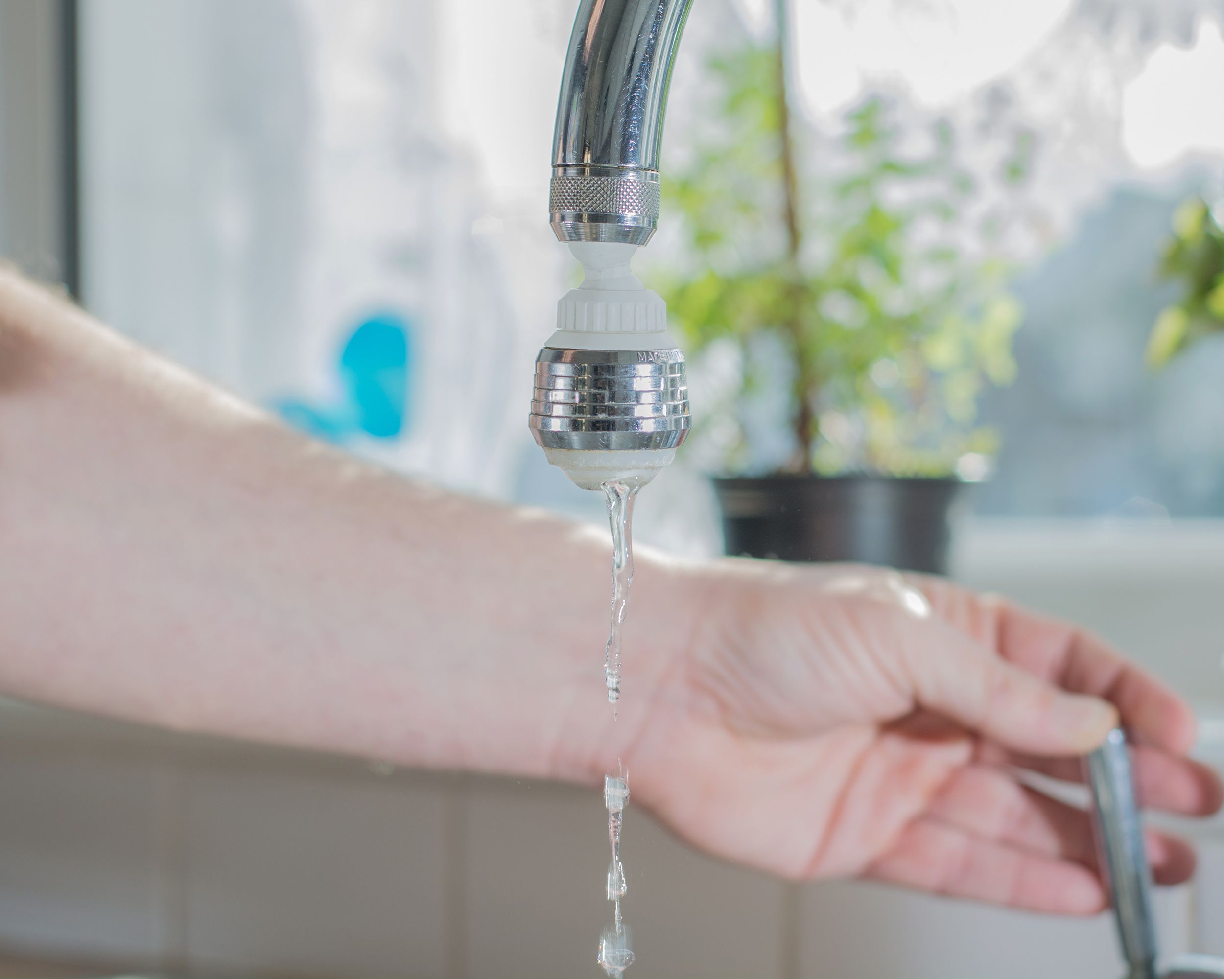 hand turning off faucet