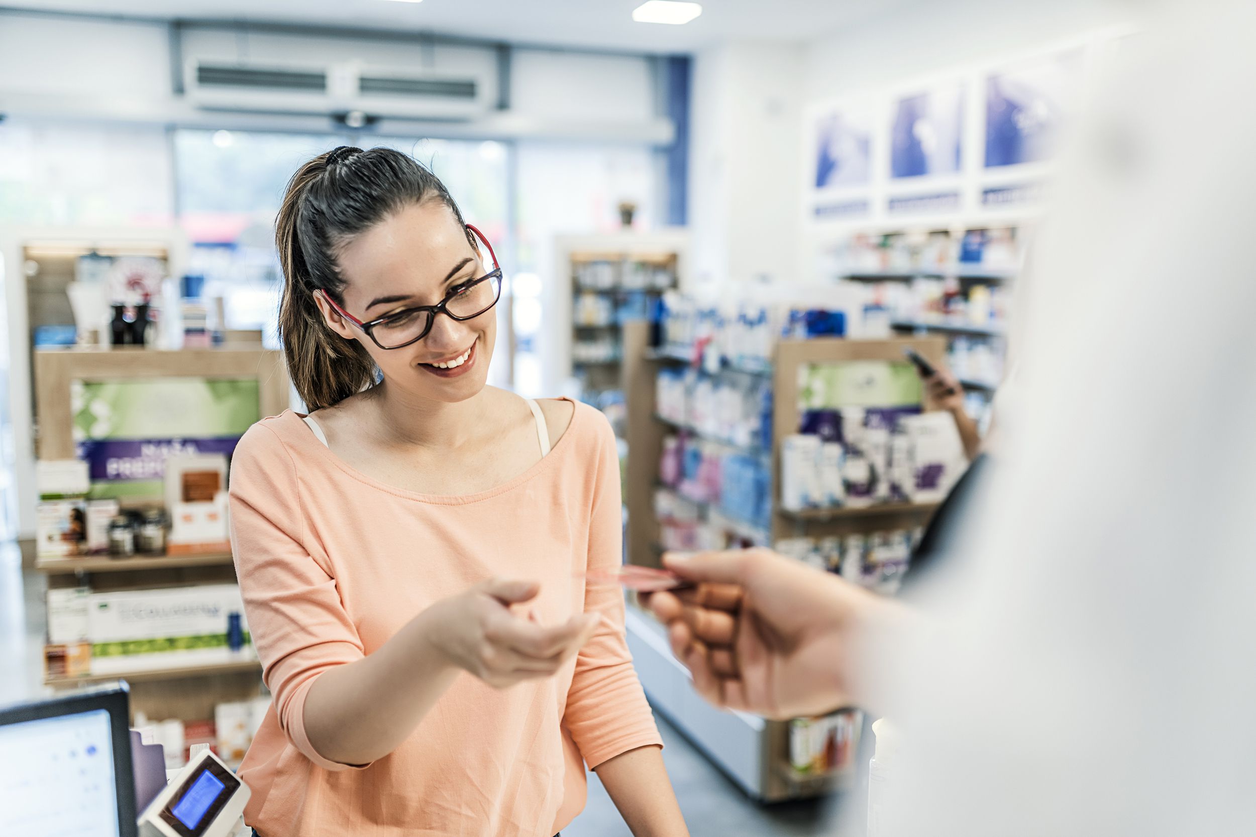 woman paying for meditation at pharmacy