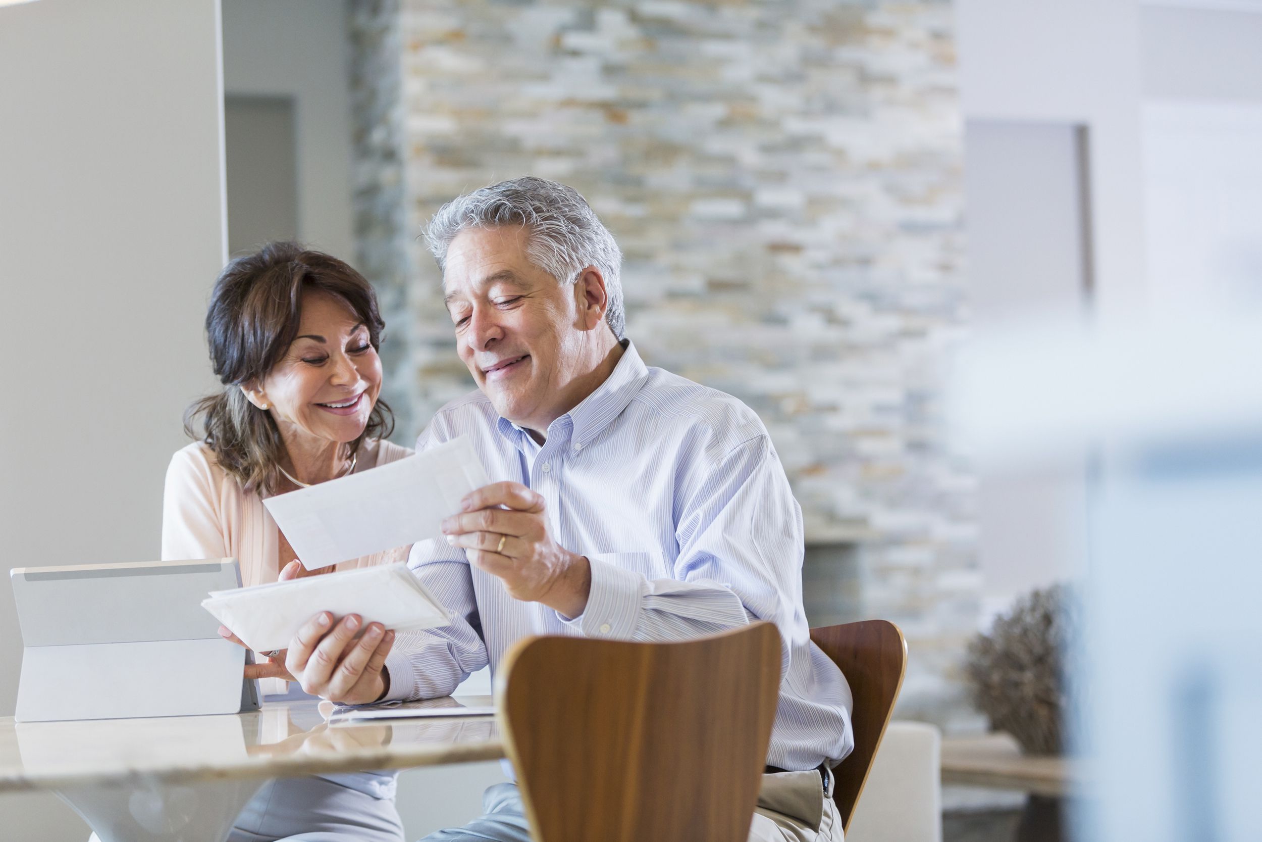 senior couple paying bills online