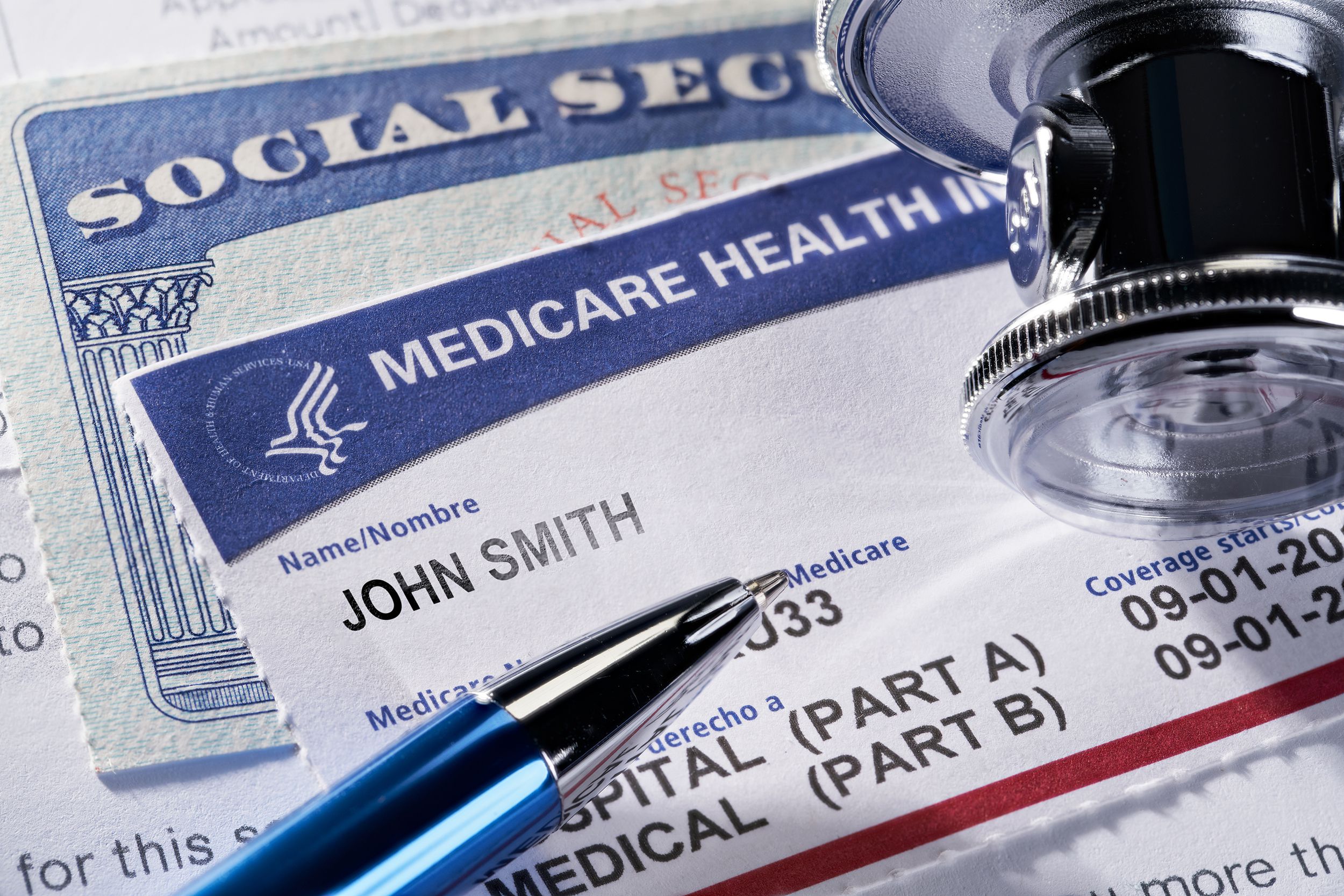 medicare health insurance and social security card on medical report and stethoscope