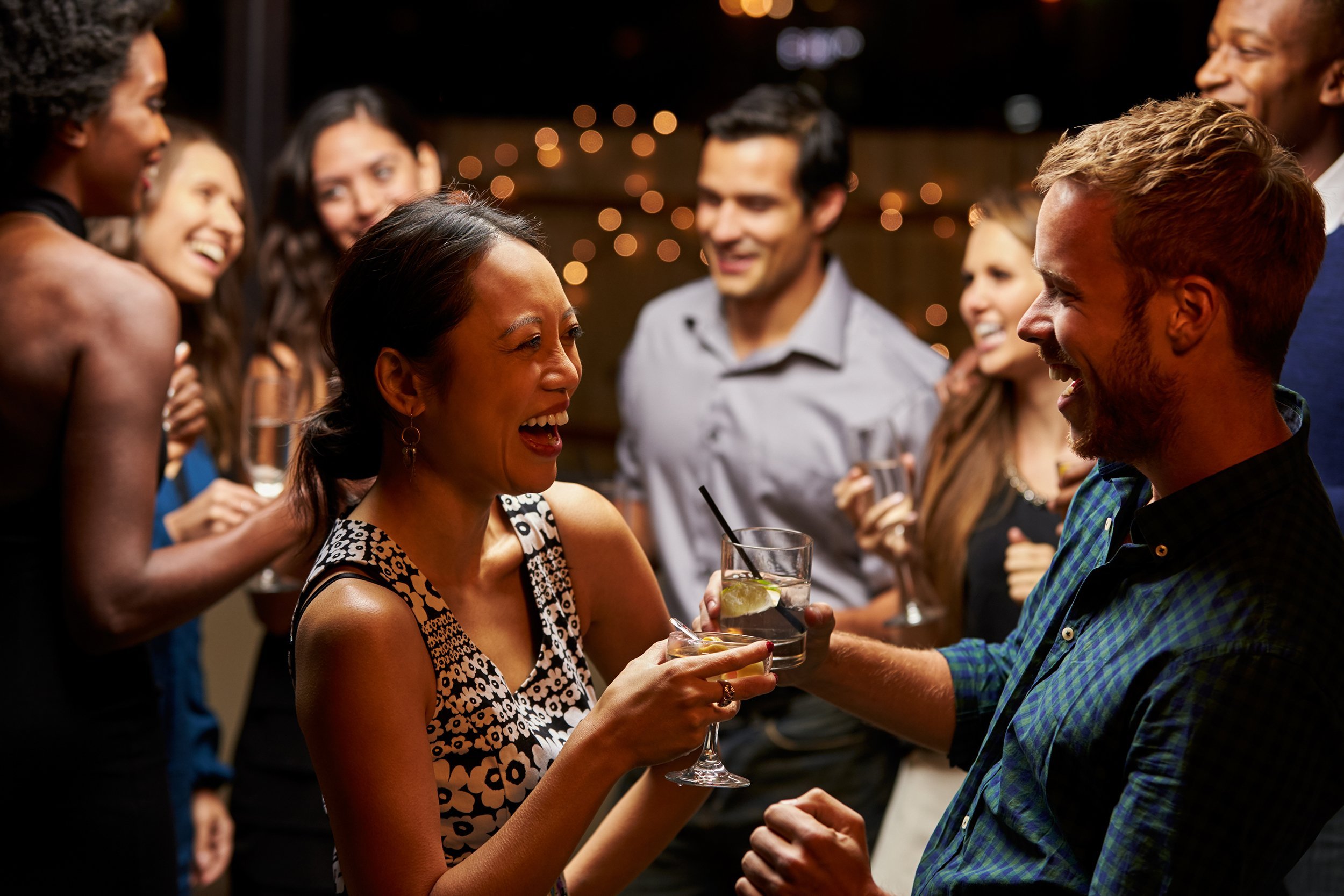 couples dancing and drinking at evening party