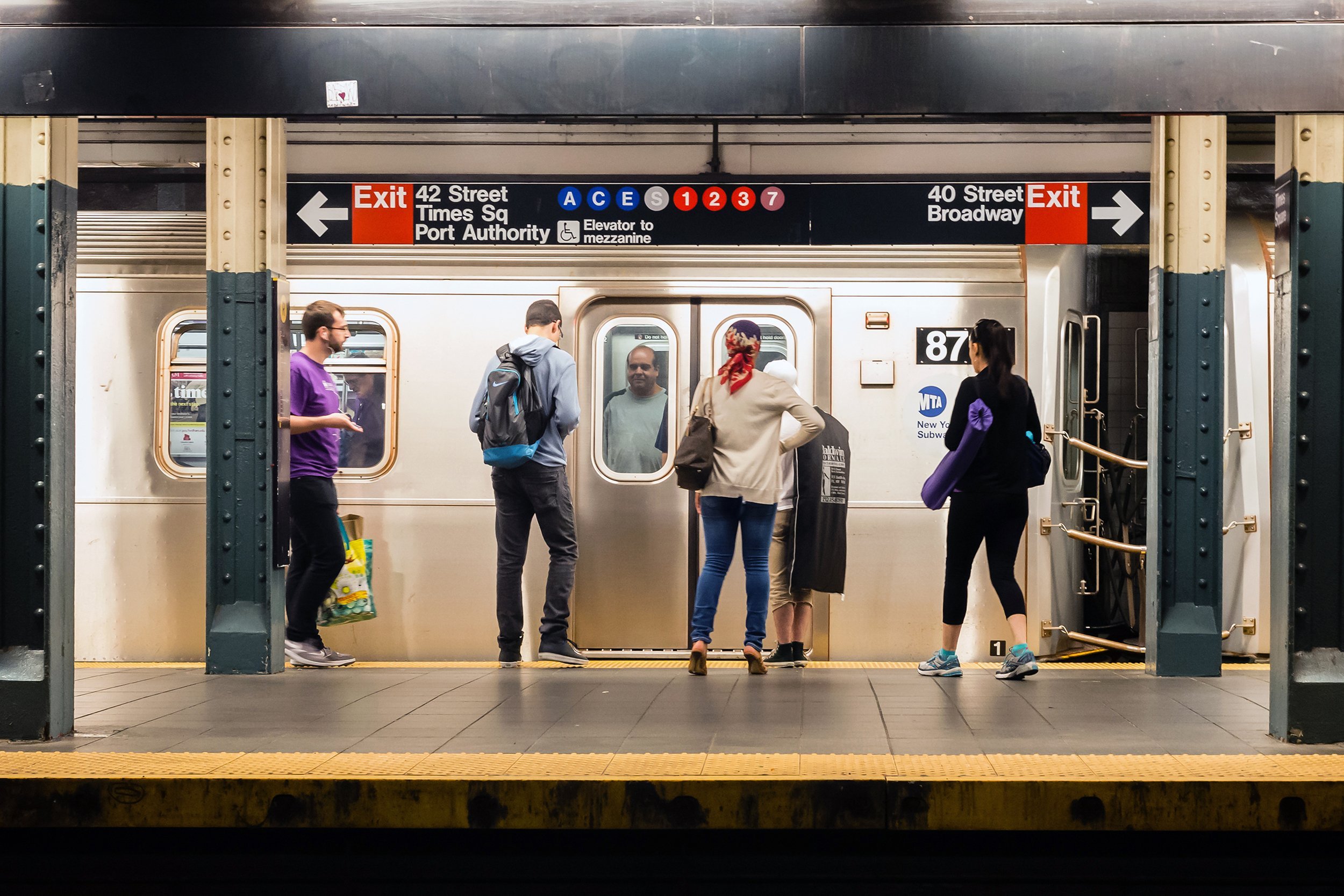 people getting on MTA subway in NYC