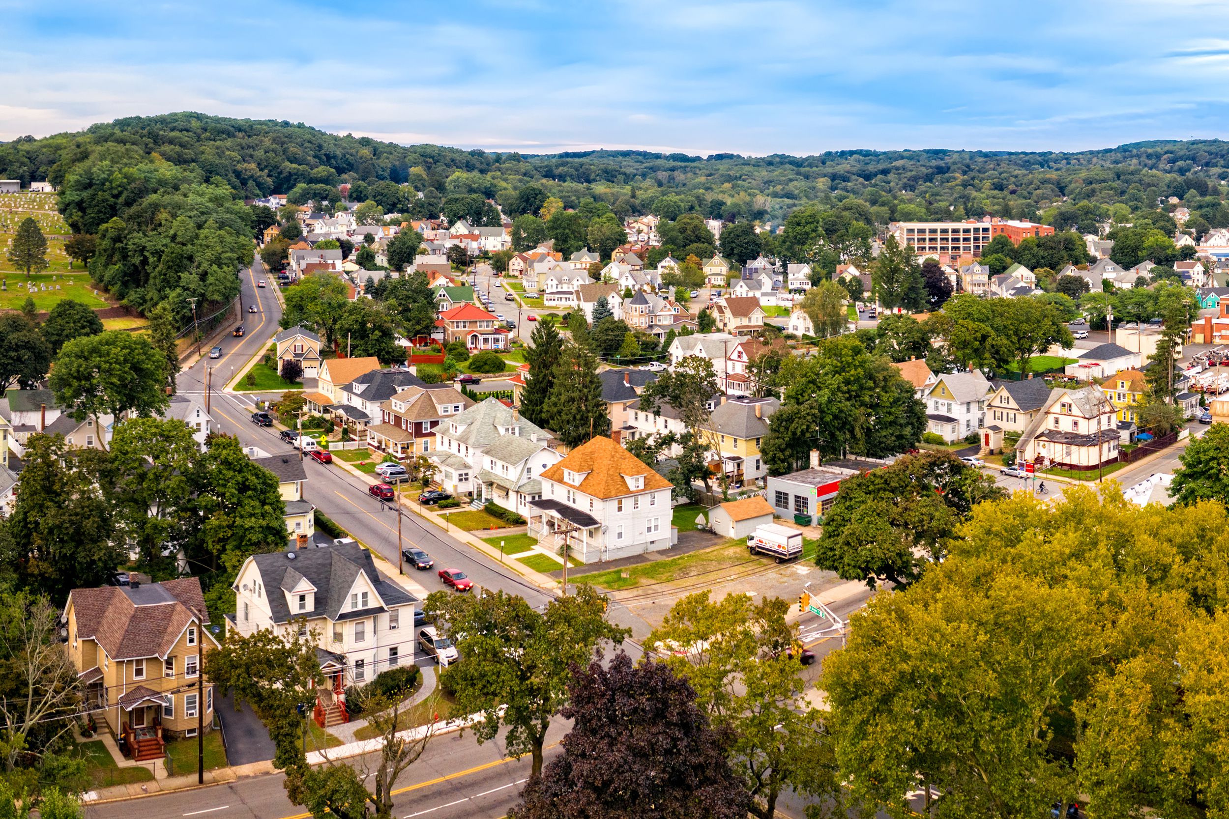 Aerial cityscape of Dover, New Jersey, on a late sunny summer day, numerous streets of homes and buildings