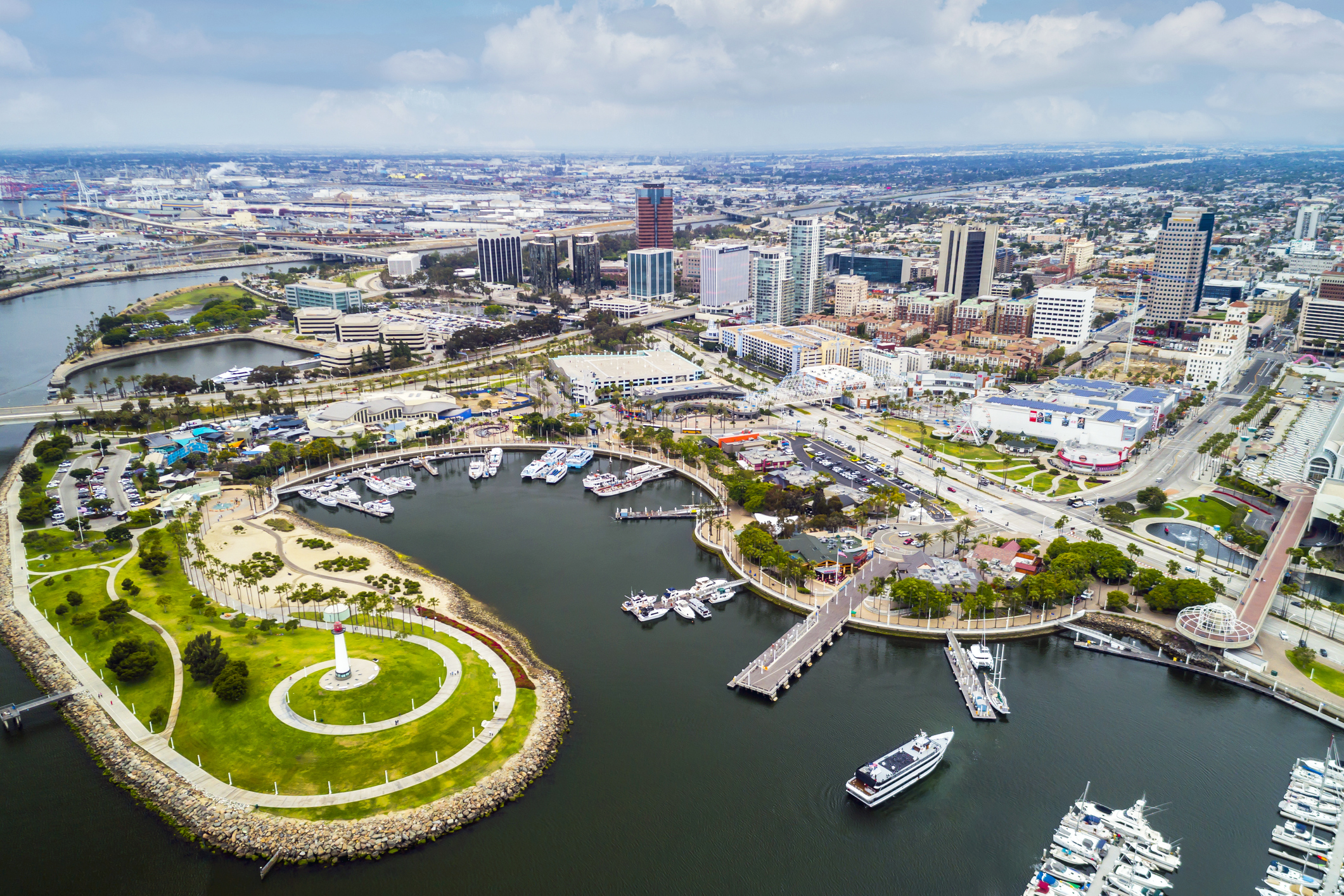 Aerial of the Pike Area in Long Beach, California, boats in the harbor and cityscape, on a sunny day