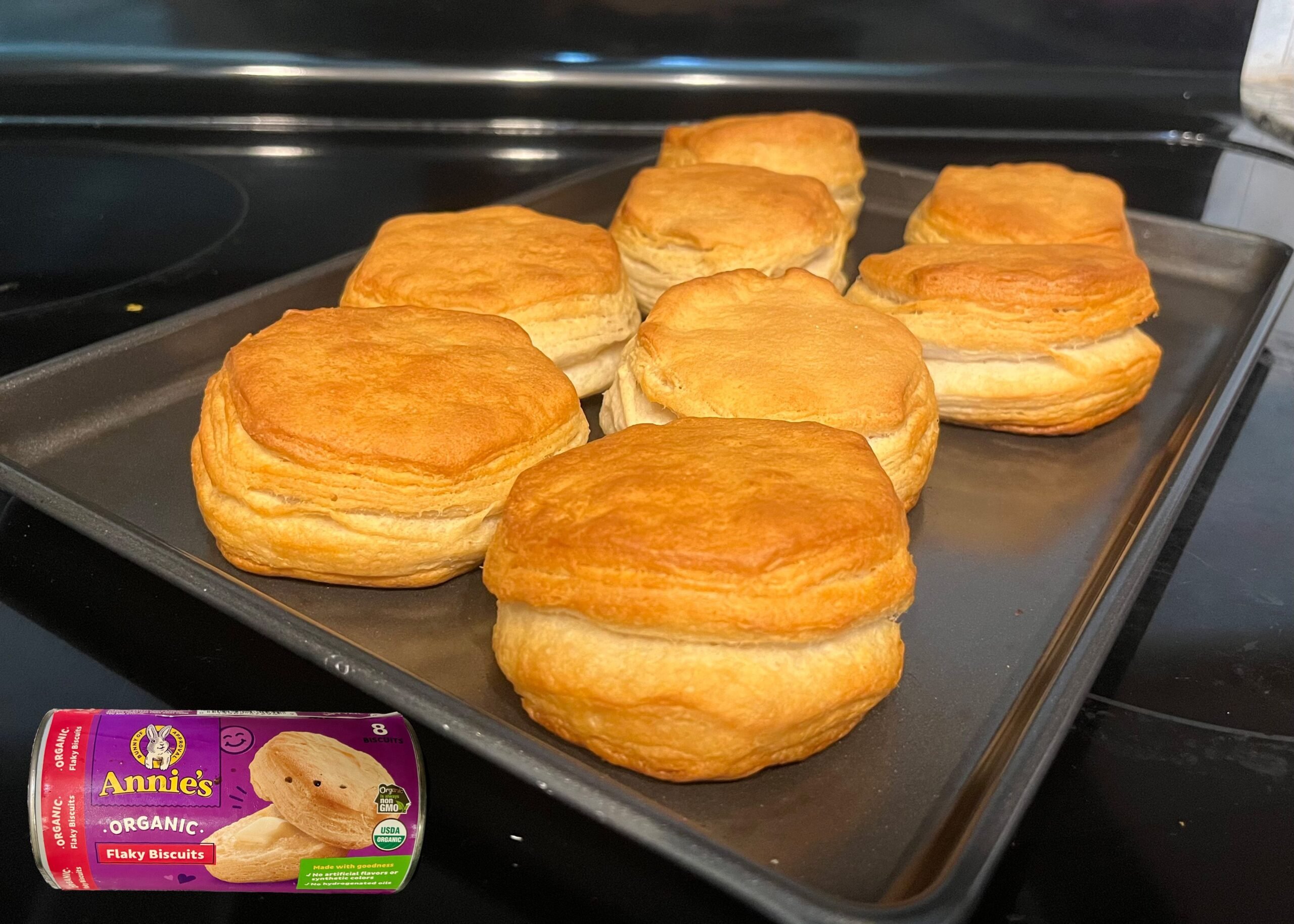 Annie’s Organic Flaky Biscuits baked on a tray with an overlay of product can