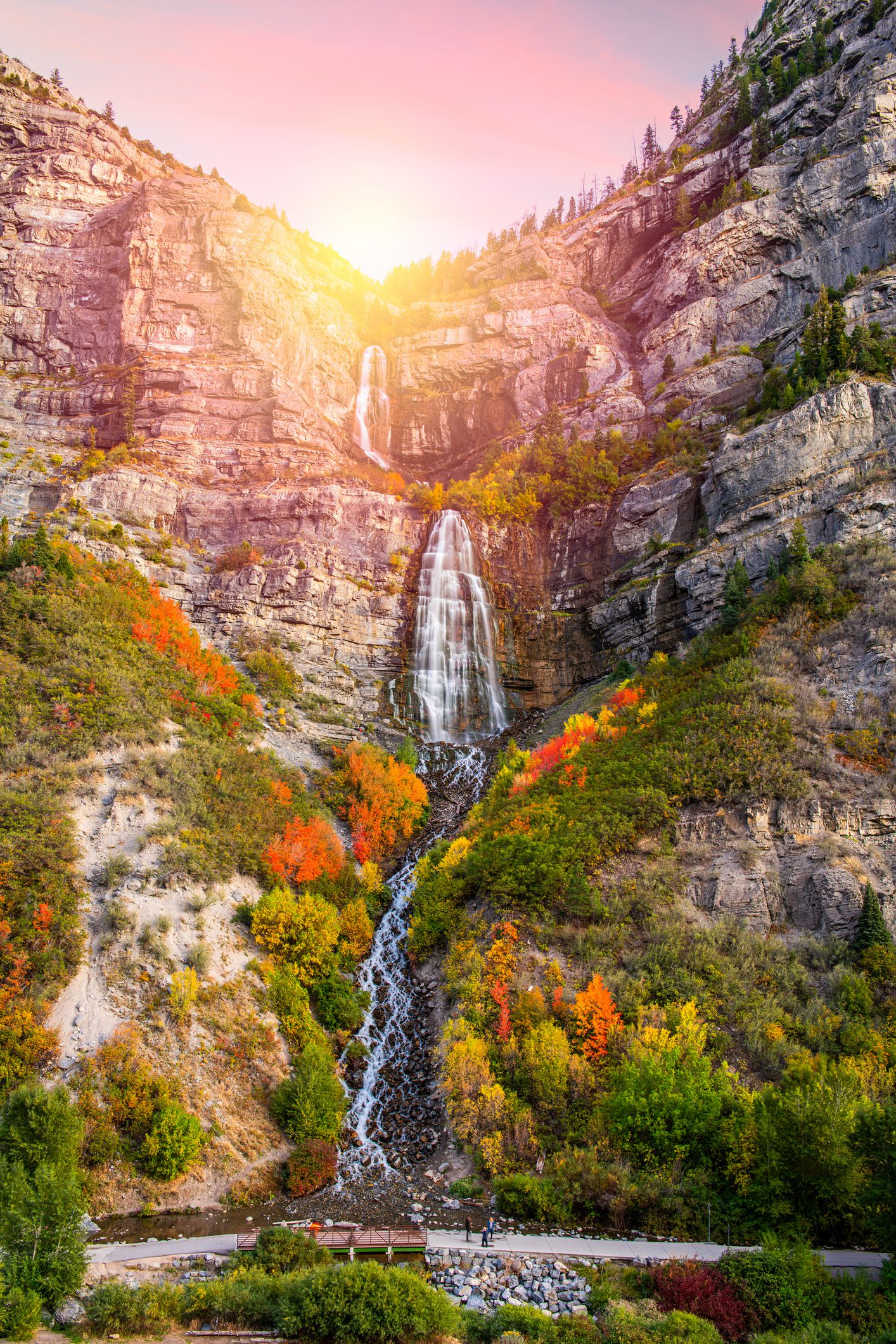 Bridal Veil Falls, Provo Canyon, Utah at sunset, with swimming hole during autumn approaching the height of colorful leaves
