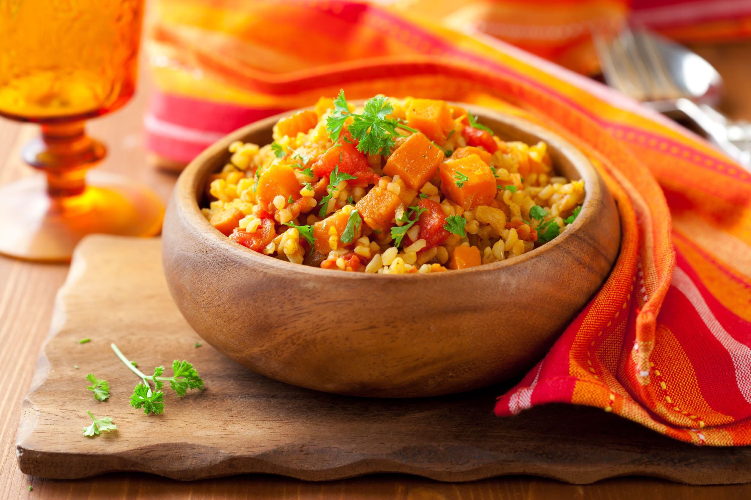Butternut Squash and Orange-Scented Couscous in a wood bowl with fresh parsley garnish