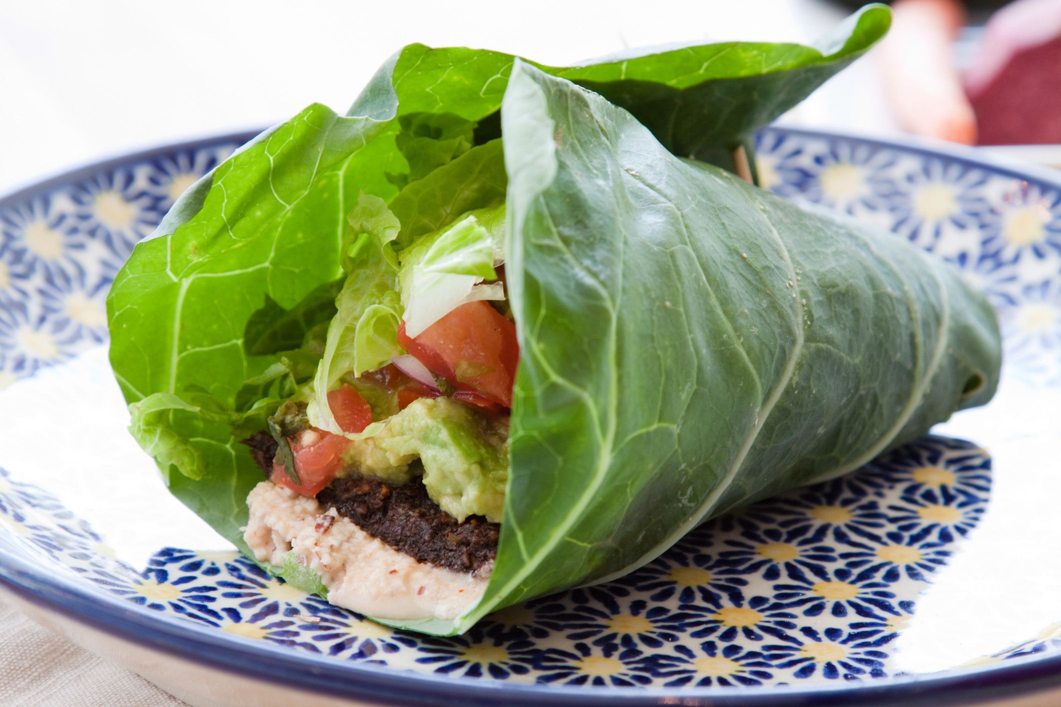 Collard wrap on a blue patterned plate