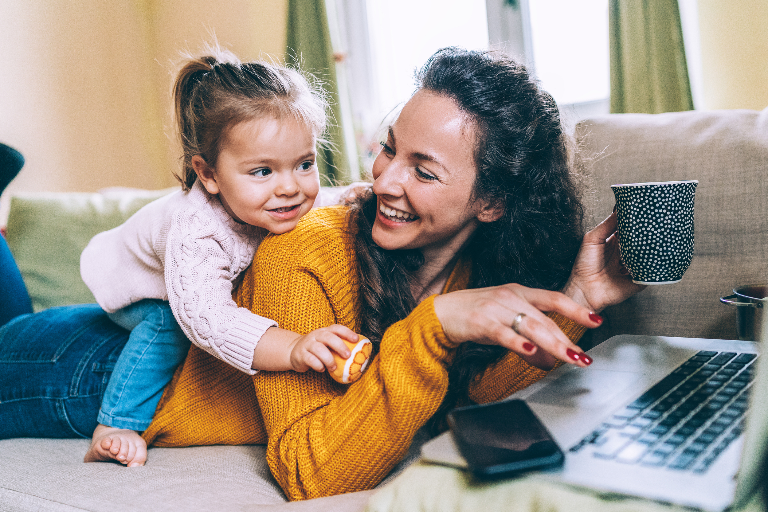 Mother on laptop with daughter