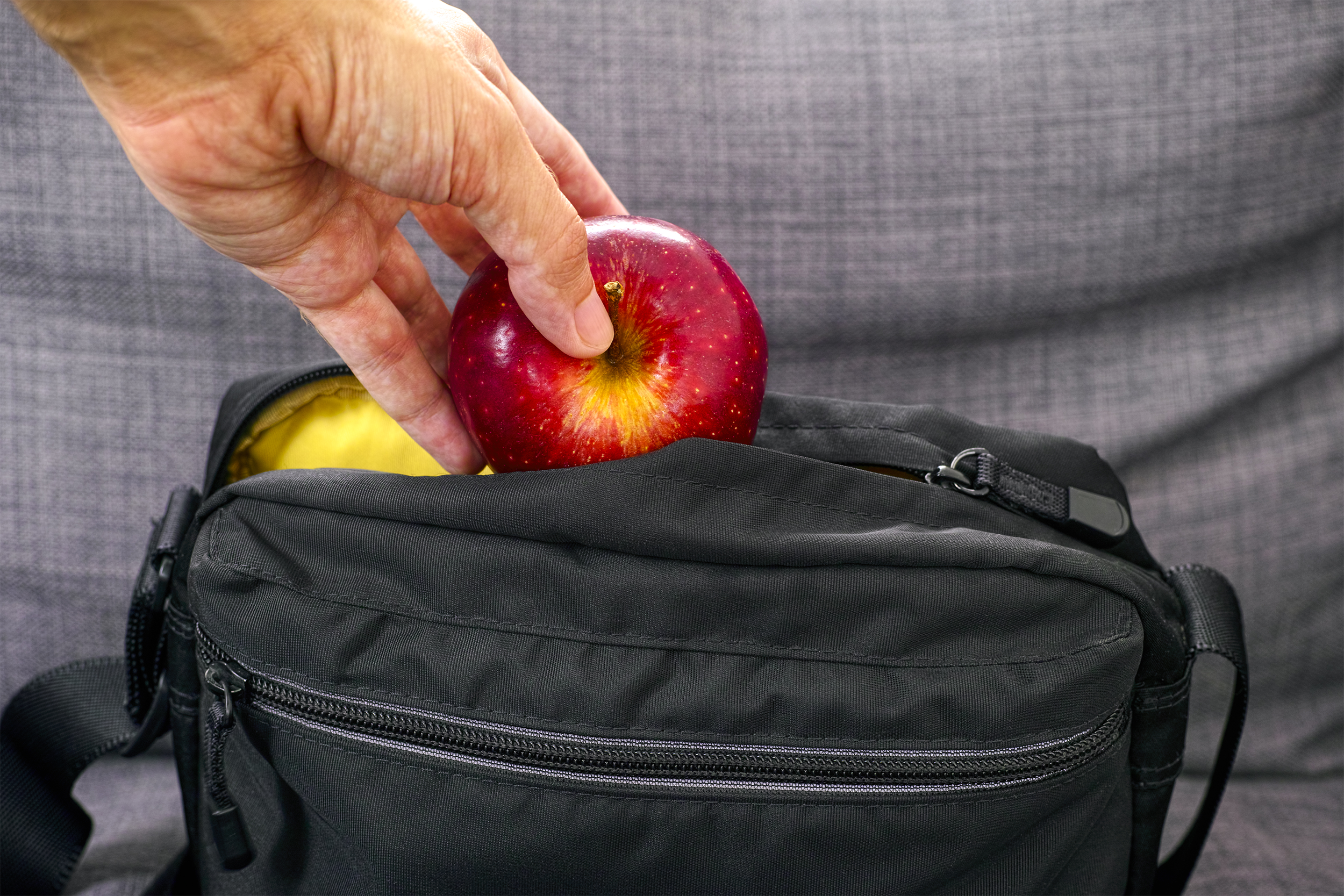Pulling an apple out of a purse