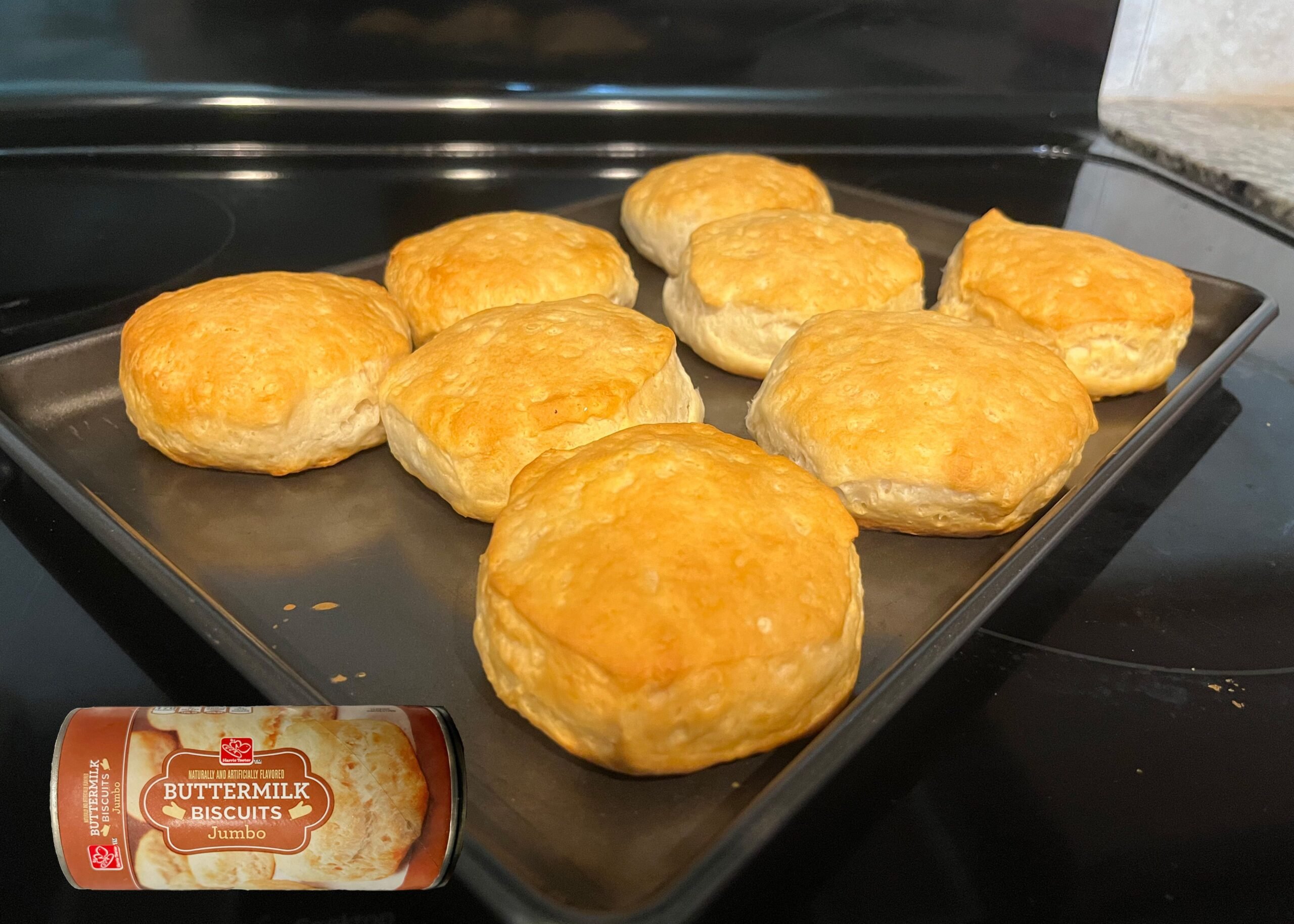 Harris Teeter Jumbo Buttermilk Biscuits baked on a tray with an overlay of product can