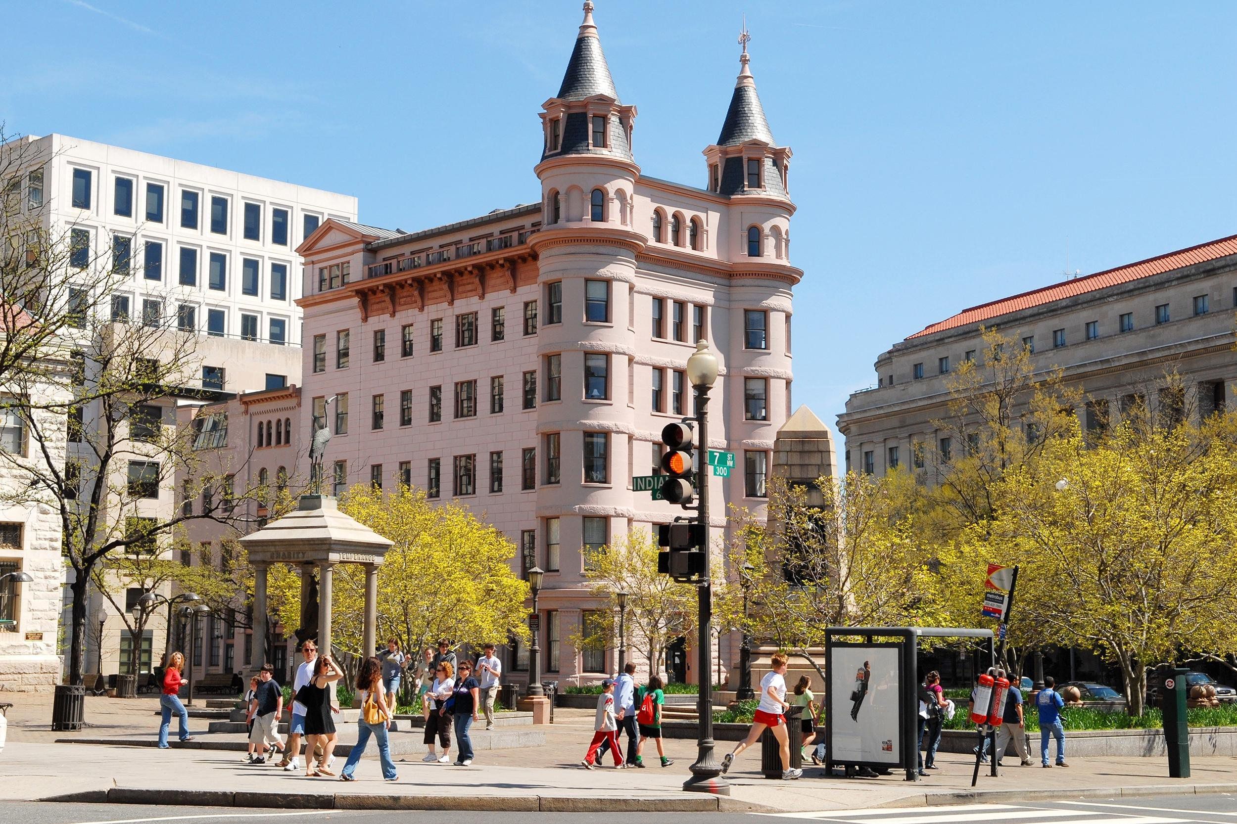Historic architecture in downtown Washington, D.C., people walking in a park area, on a sunny autumn day