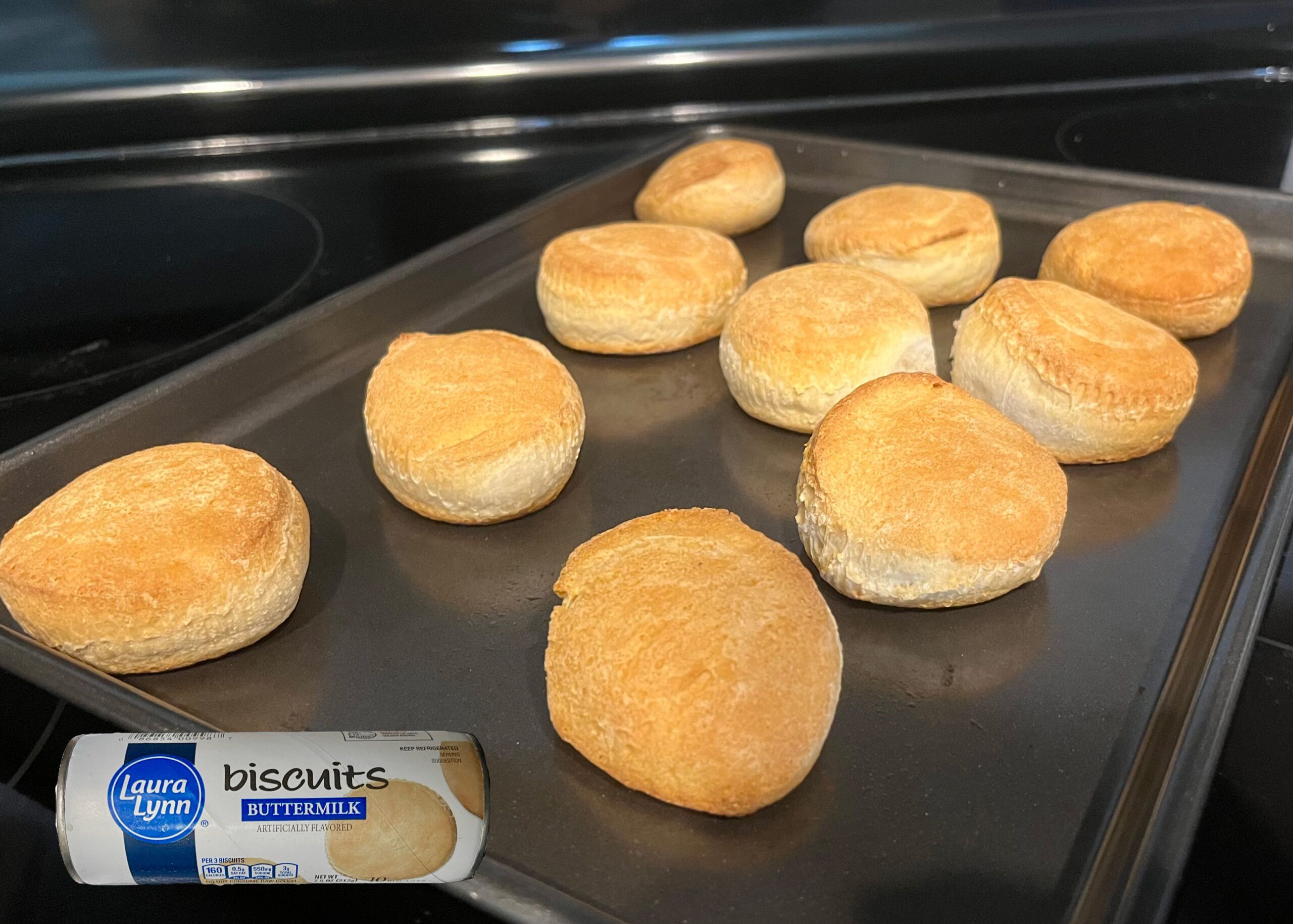 Laura Lynn Buttermilk Biscuits baked on a tray with overlay of product can