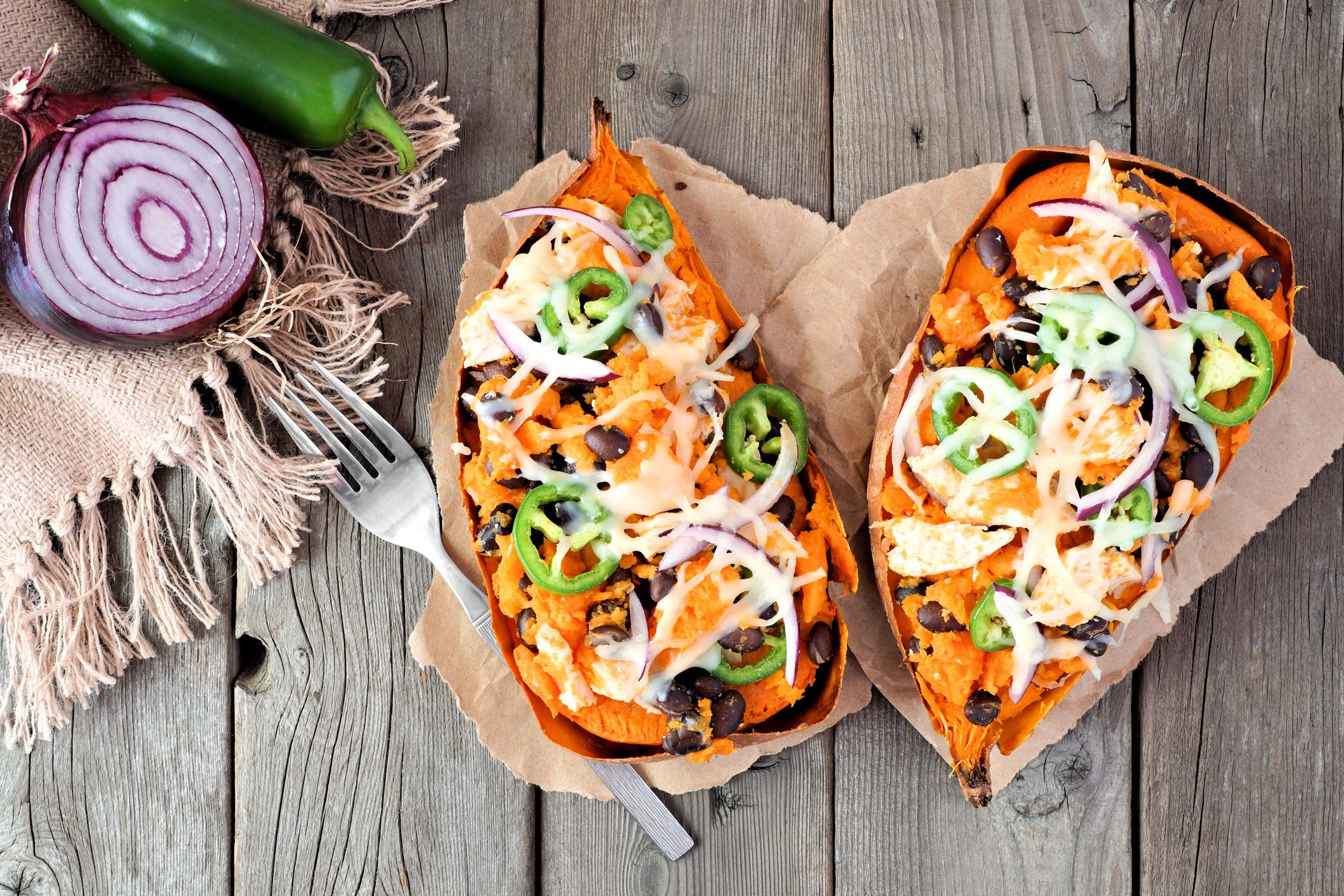 loaded sweet potato on a rustic wood table