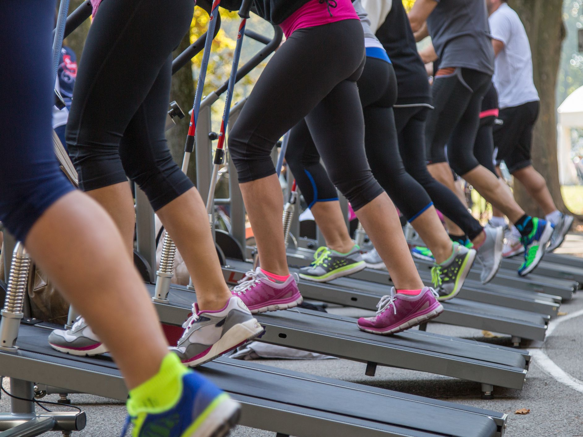 Women in Sportswear Exercising Outdoor on Treadmills at Public Location Inside Cittadella Park in Summer Time during Public Fitness Festival in Parma