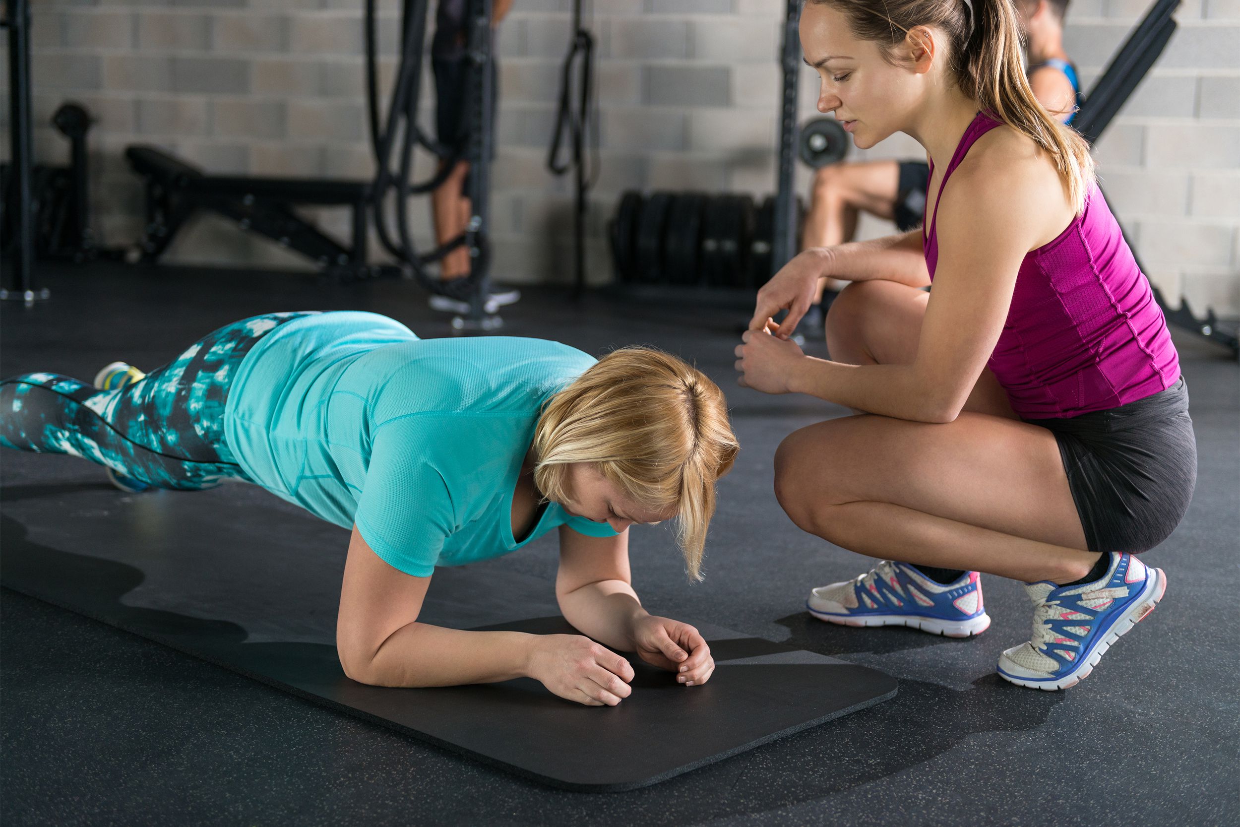 Female personal trainer with her client