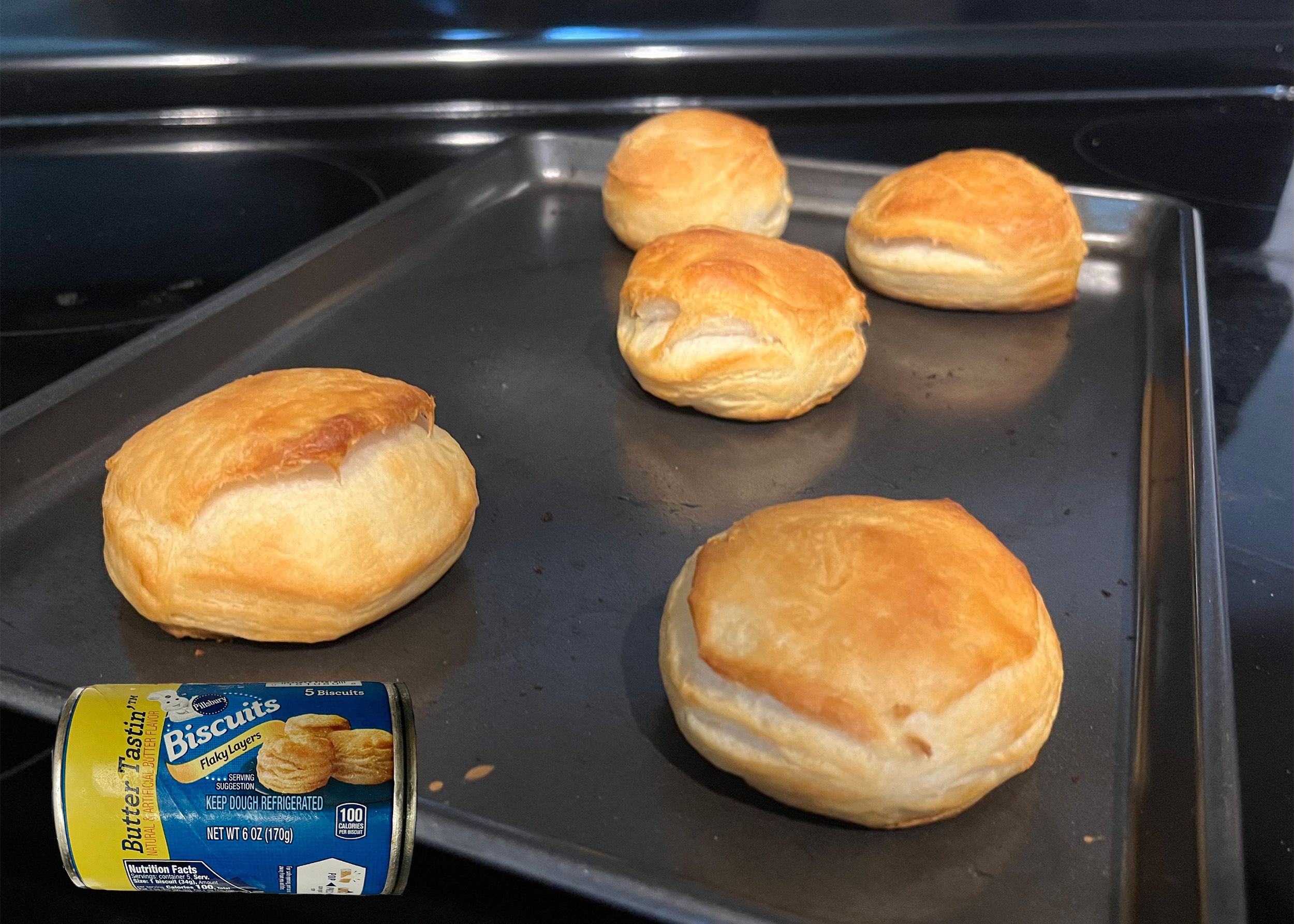 Pillsbury Butter Tastin’ biscuits baked on a tray with an overlay of product can
