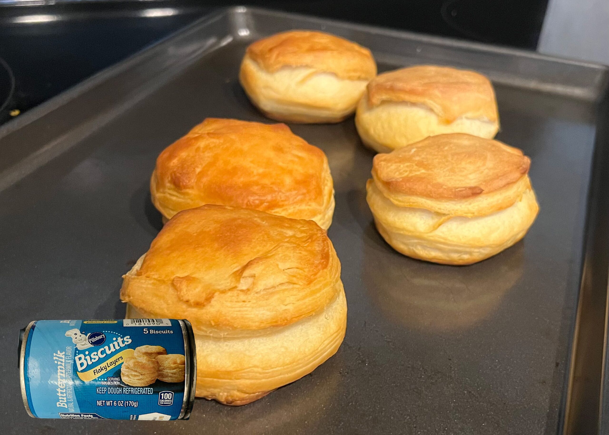Pillsbury Buttermilk Biscuits baked on a tray with overlay of product can