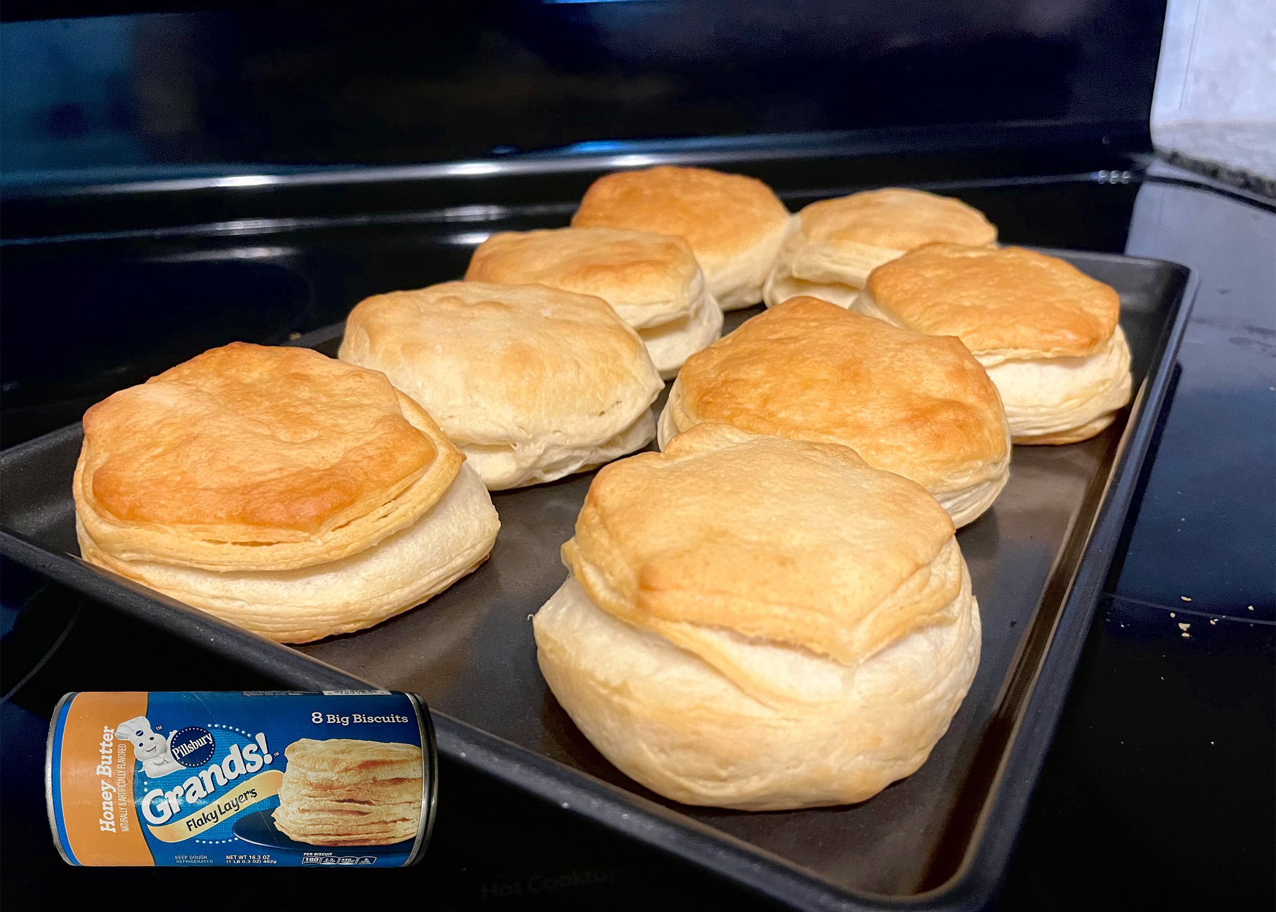 Pillsbury Honey Butter Biscuits baked on a tray with an overlay of product can