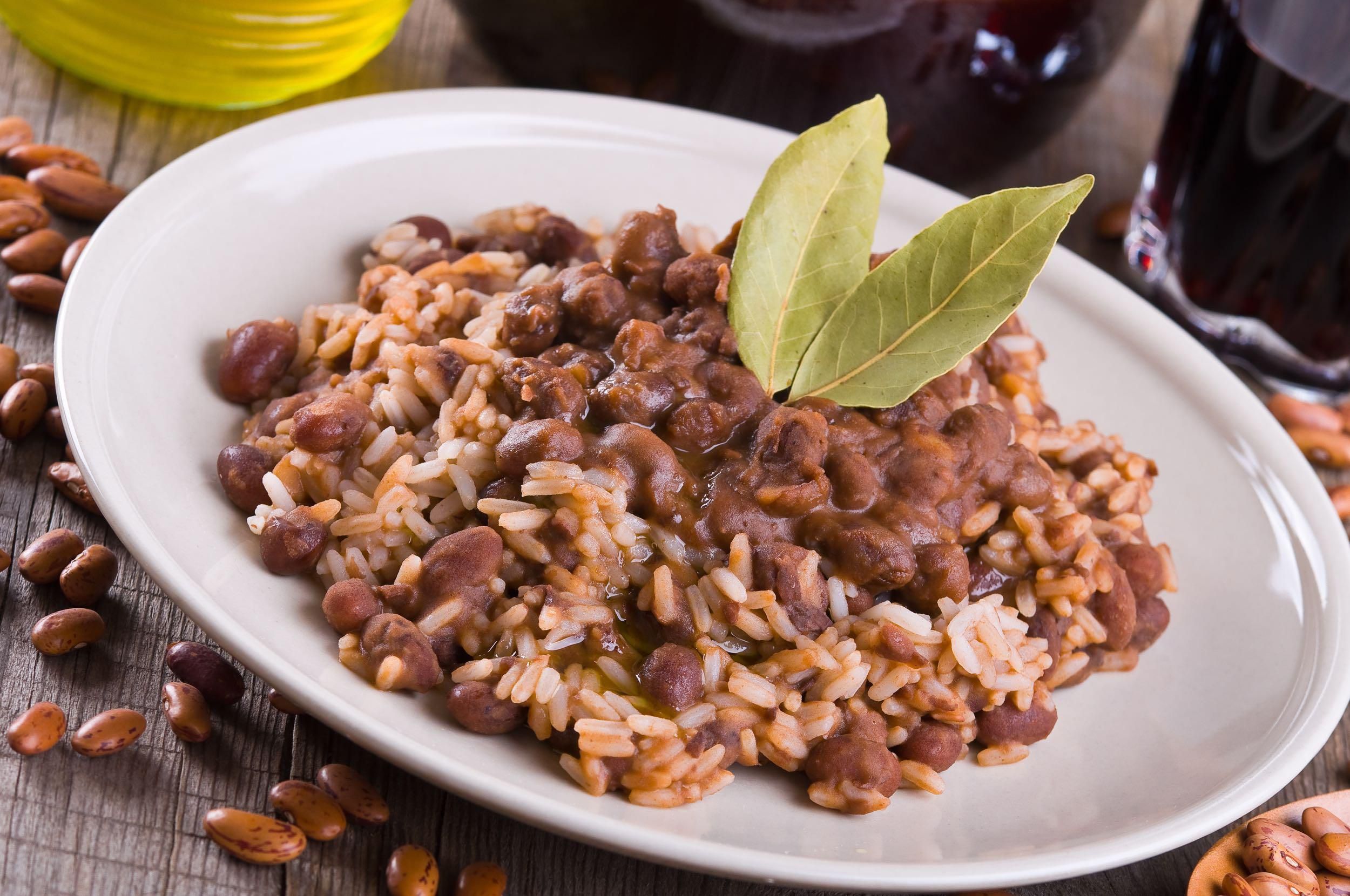 Cooked Rice and Beans with two bay leaves as decoration on a white plate