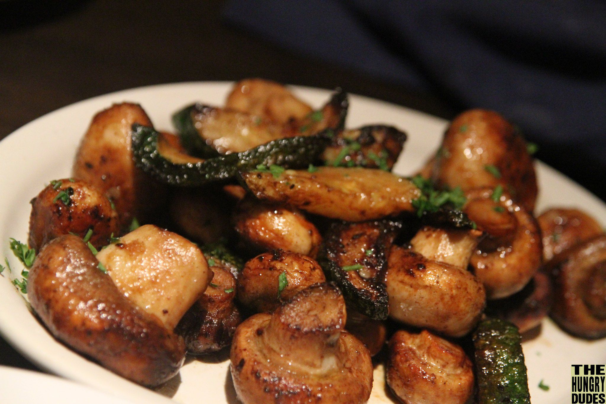 Sauteed mushrooms with greens on a plate